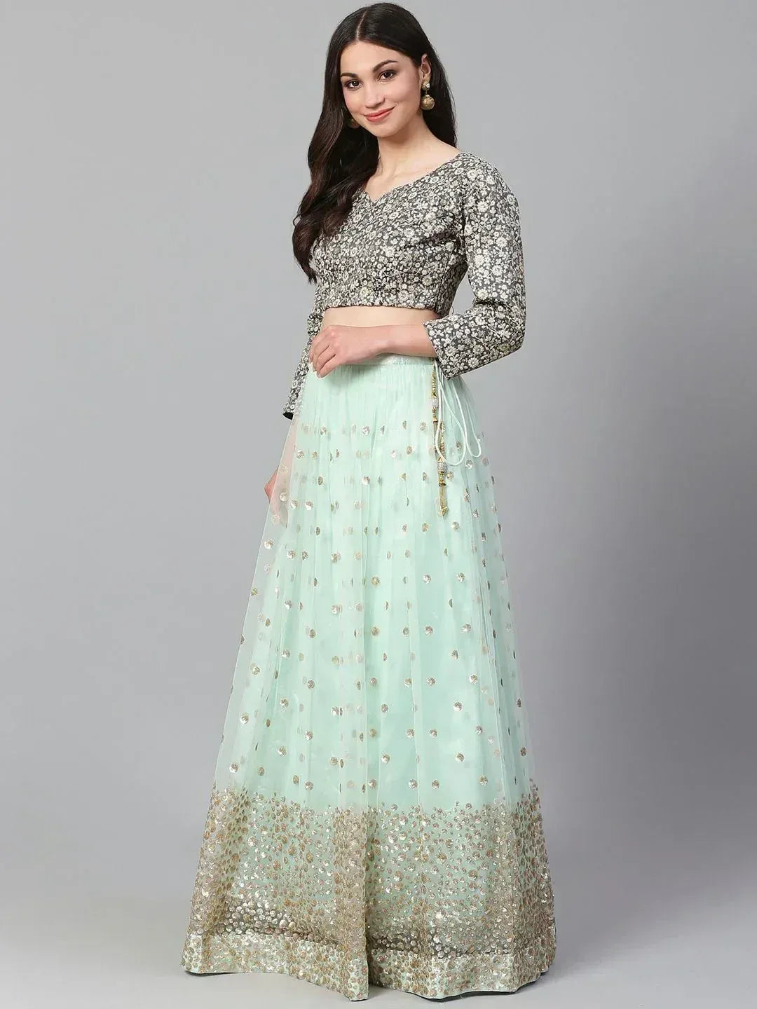 Mint green lehenga choli with gold embroidery and floral blouse, perfect for Indian ethnic occasions.