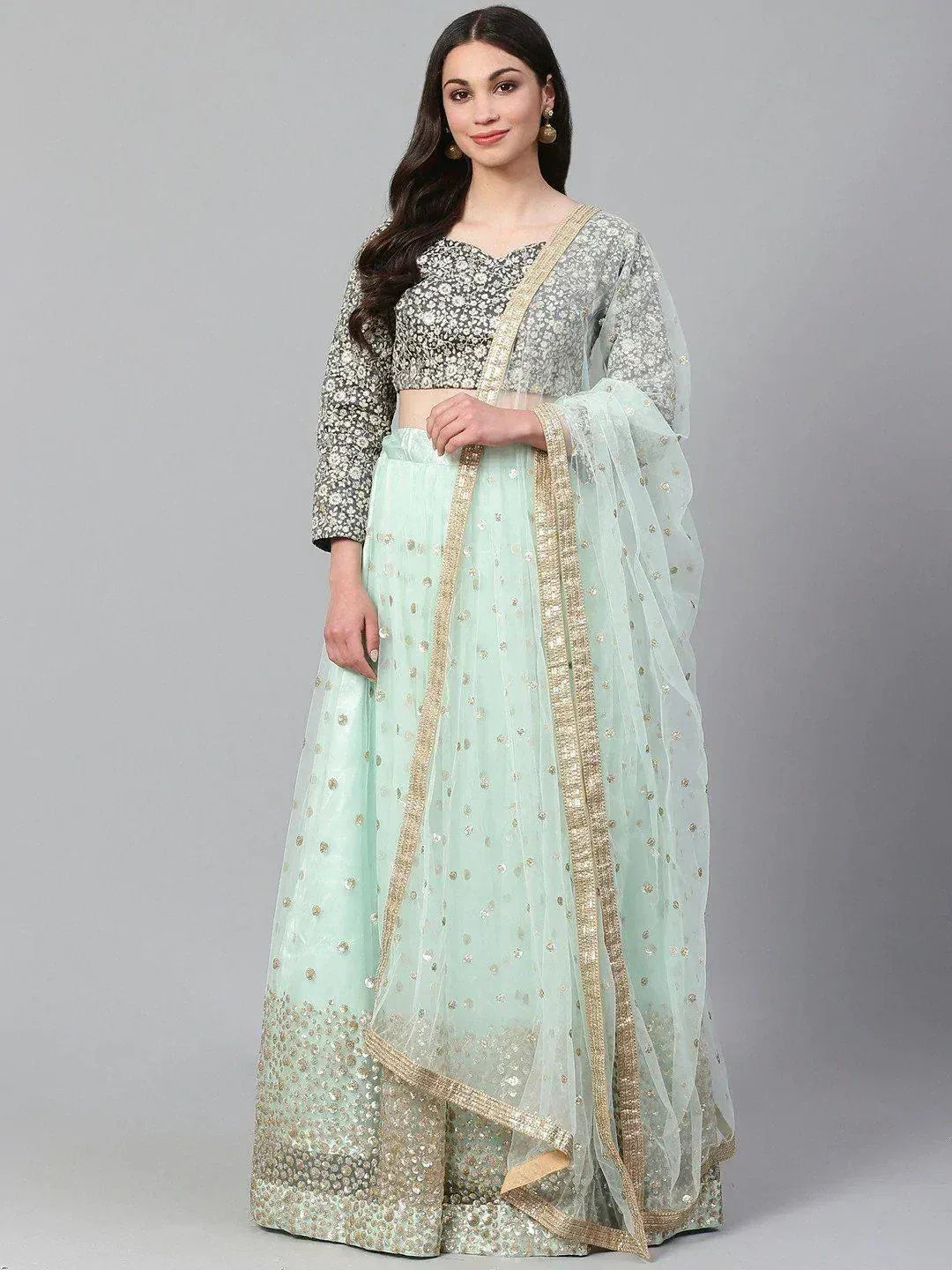 Mint green lehenga choli with gold embroidery, sheer dupatta, and floral blouse for Indian ethnic wear