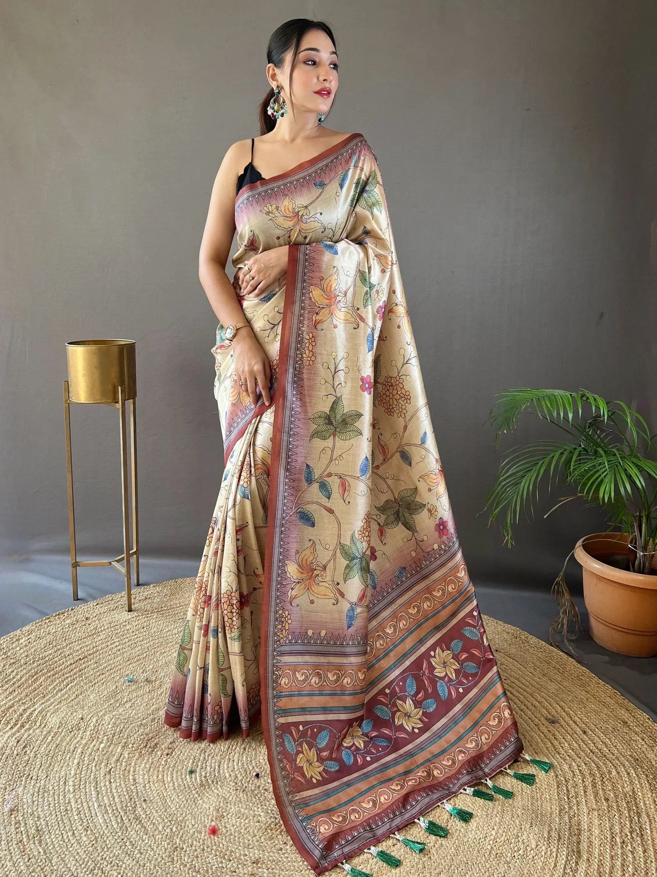 Woman in floral printed ethnic saree with tassels, perfect for Indian occasions and festivals.