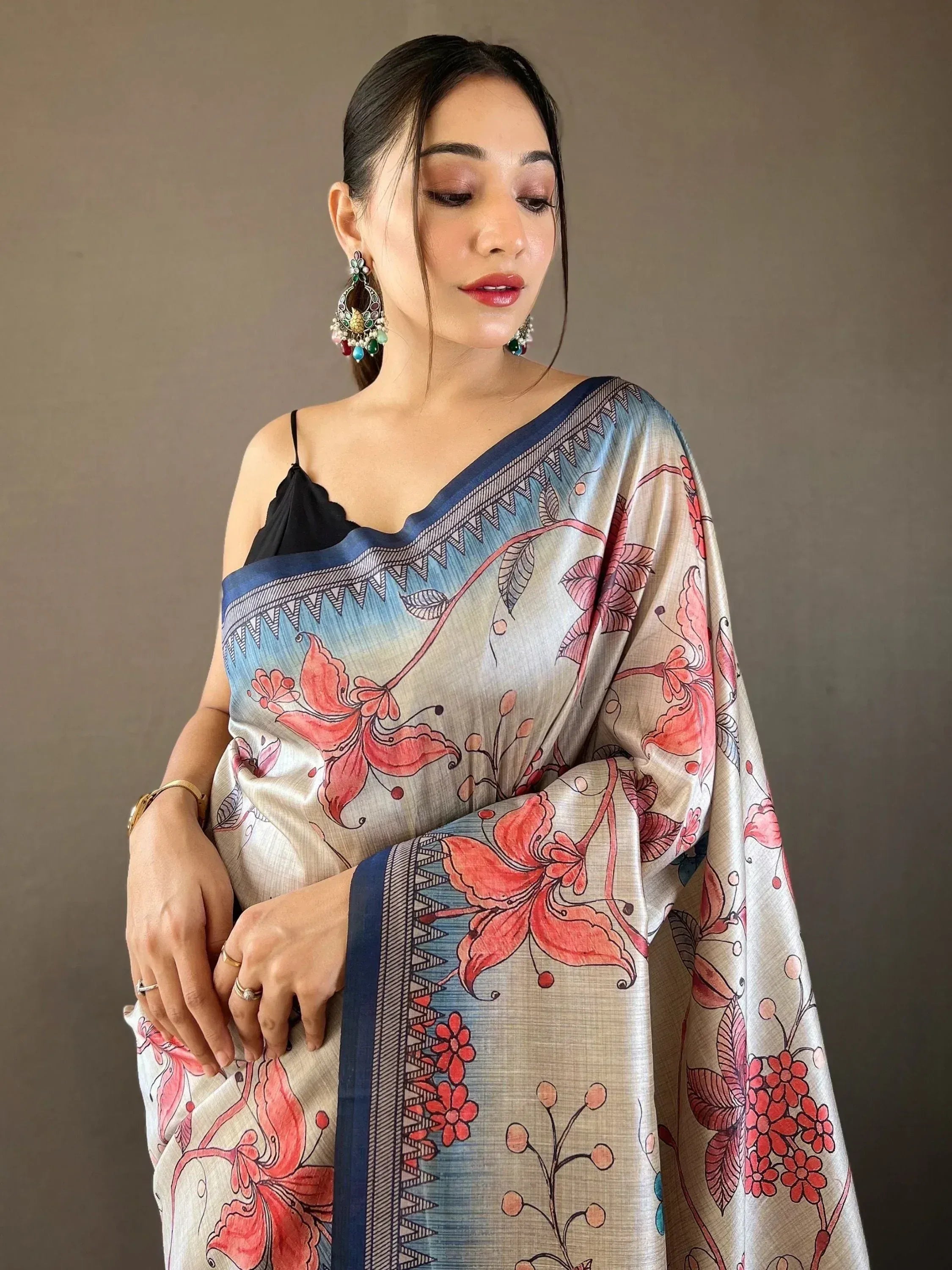 Woman in floral print saree with blue border, ethnic Indian wear, designer saree style