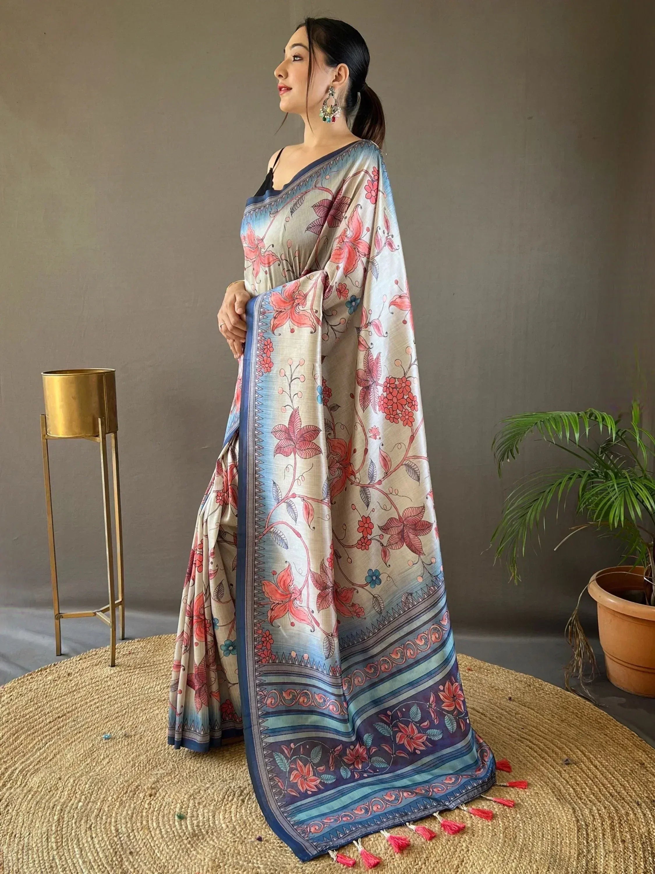 Woman in floral print saree with blue border and tassels, Indian ethnic wear