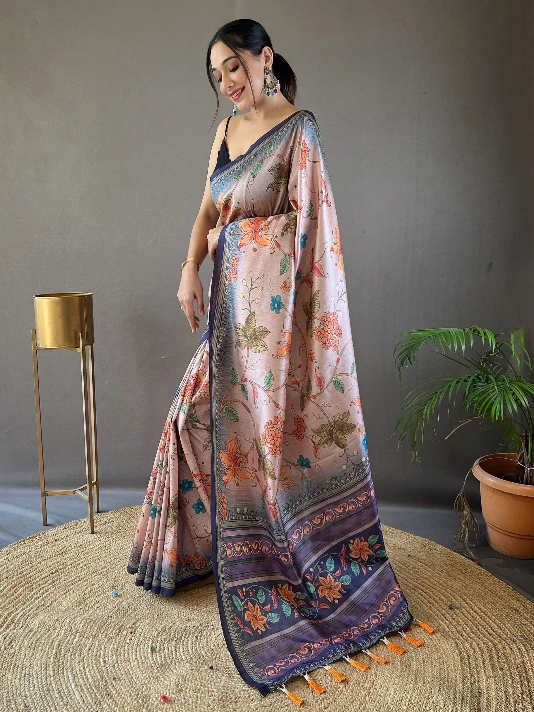 Woman in floral printed saree with blue border and tassels, Indian ethnic wear