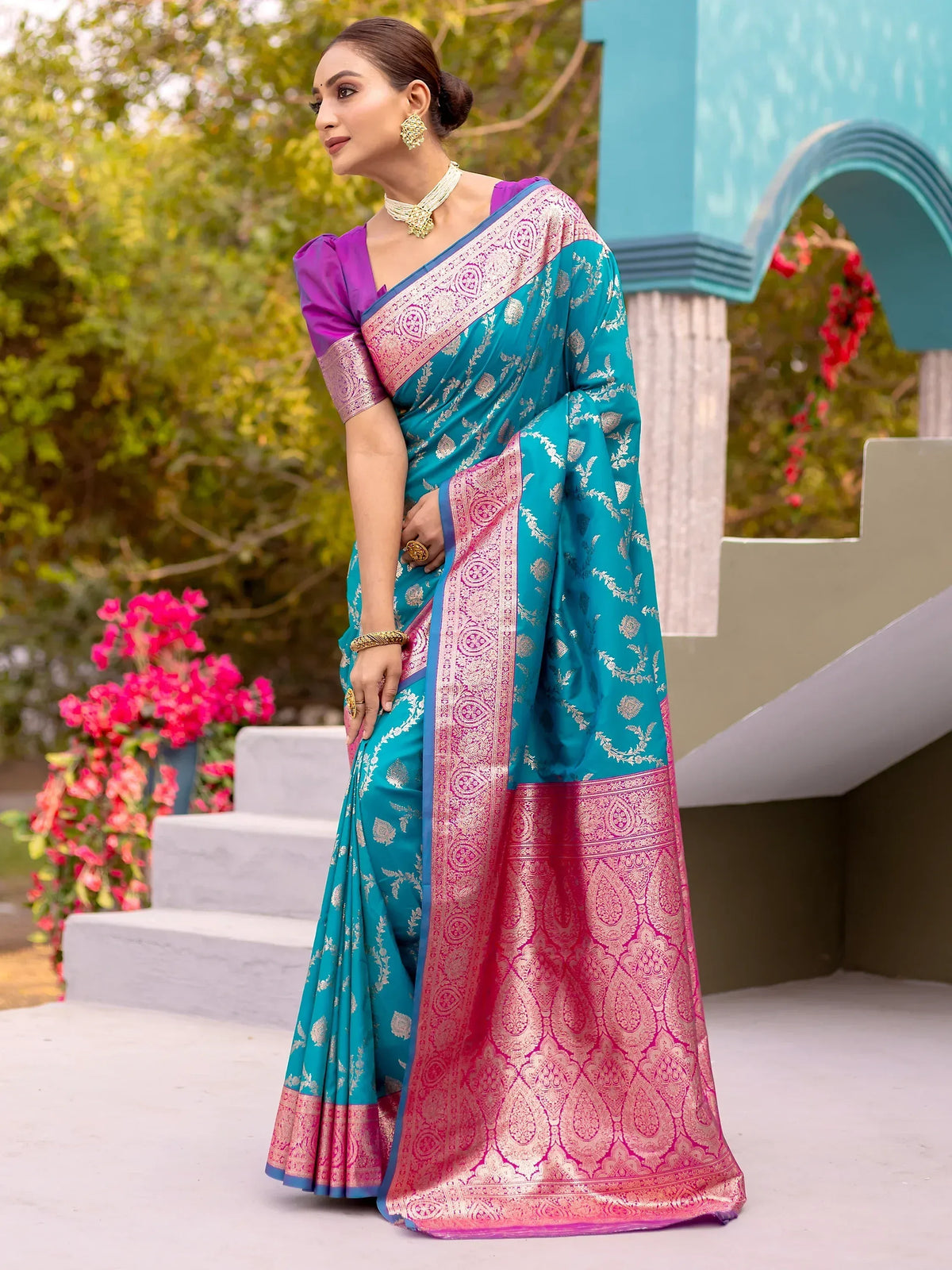 Teal and pink designer saree with intricate gold embroidery, perfect for ethnic occasions