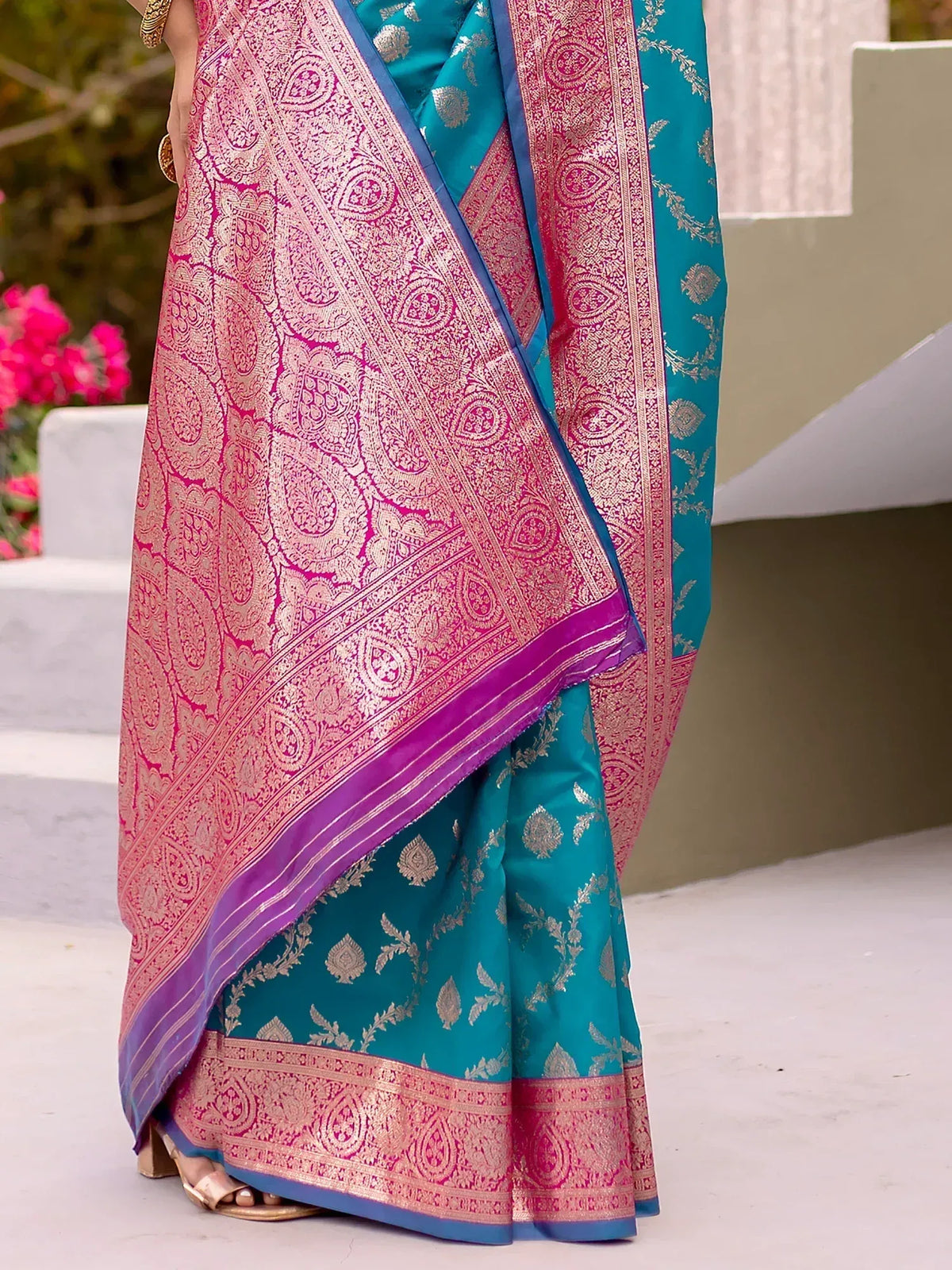 Teal and pink designer saree with intricate gold paisley patterns, perfect for ethnic wear