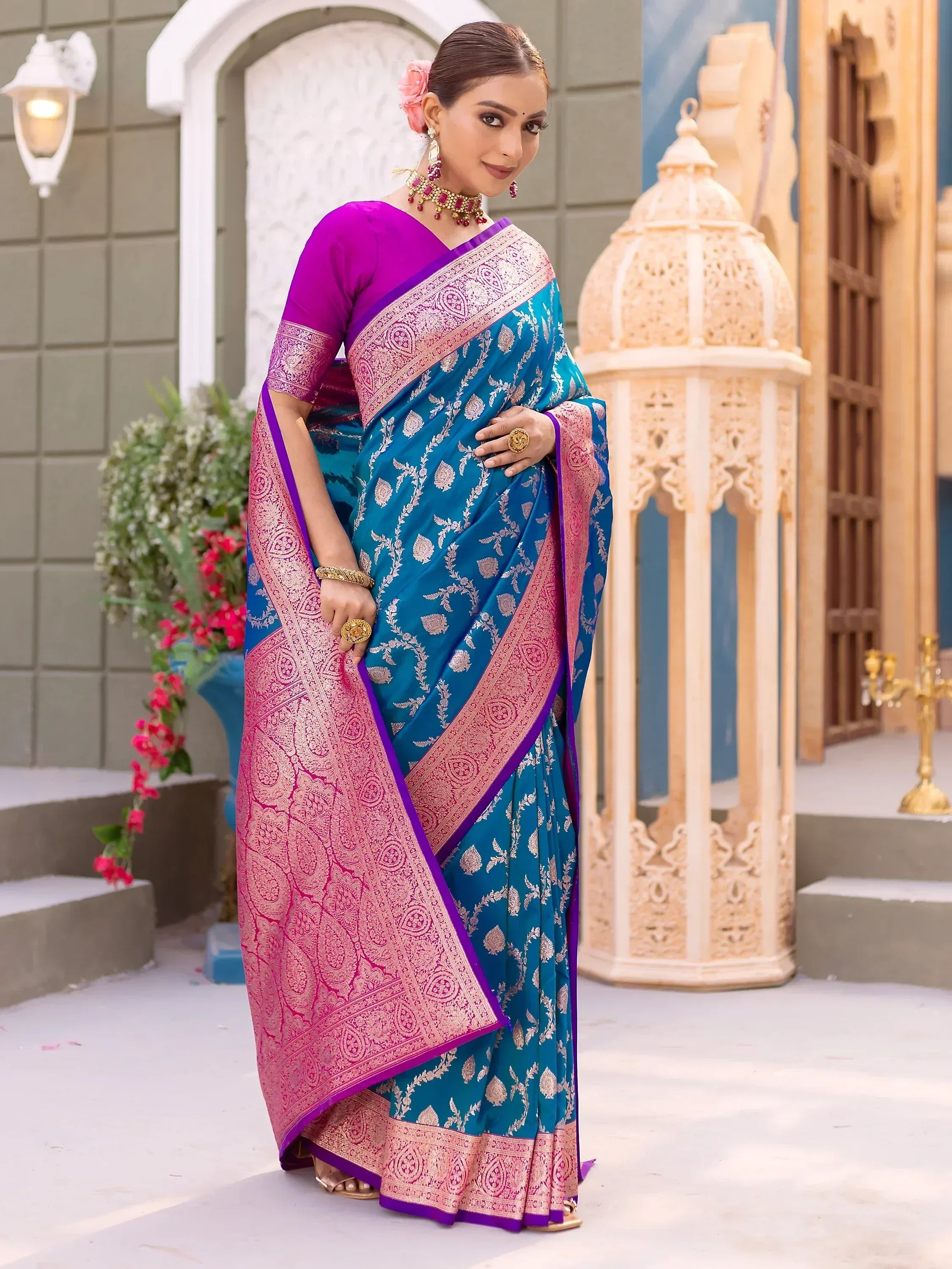Teal and pink designer saree with gold floral motifs, purple blouse, ethnic jewelry for Indian occasions