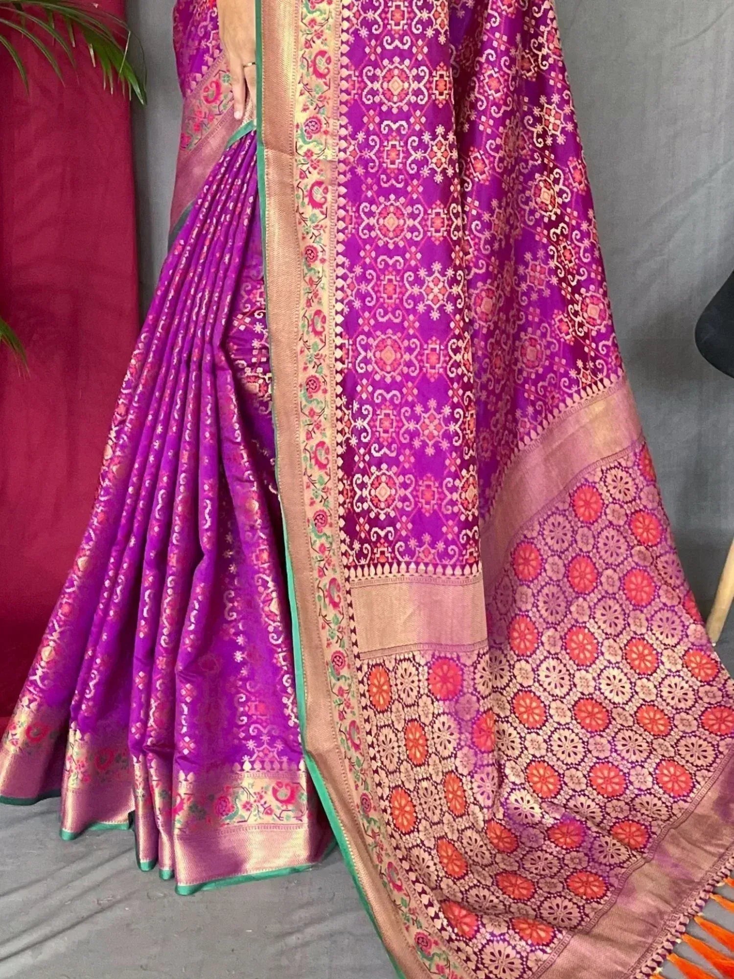 Vibrant purple Indian saree with intricate floral and geometric woven patterns, perfect for ethnic occasions.