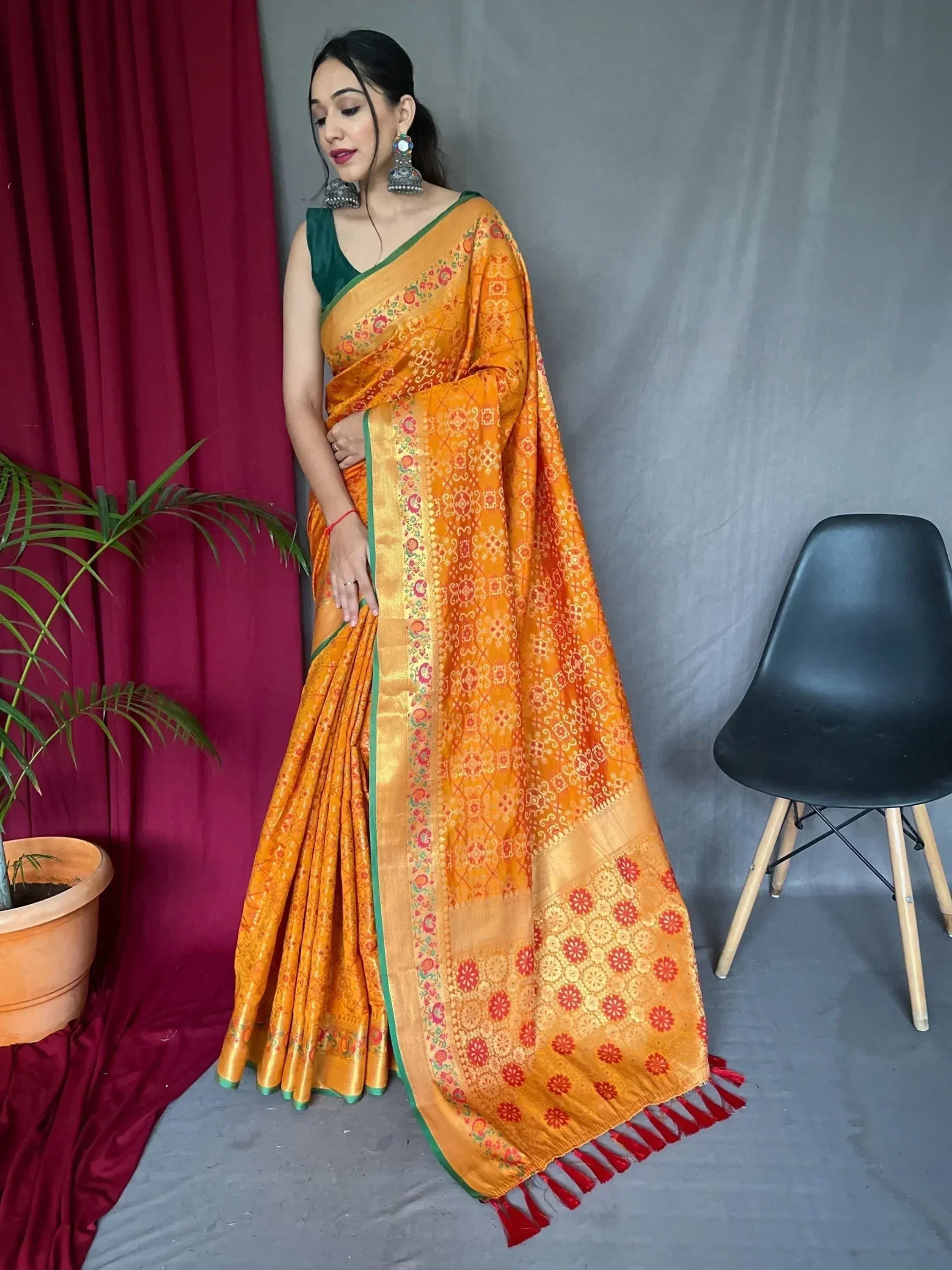 Orange floral print saree with green border and red tassels, paired with green blouse, Indian ethnic wear
