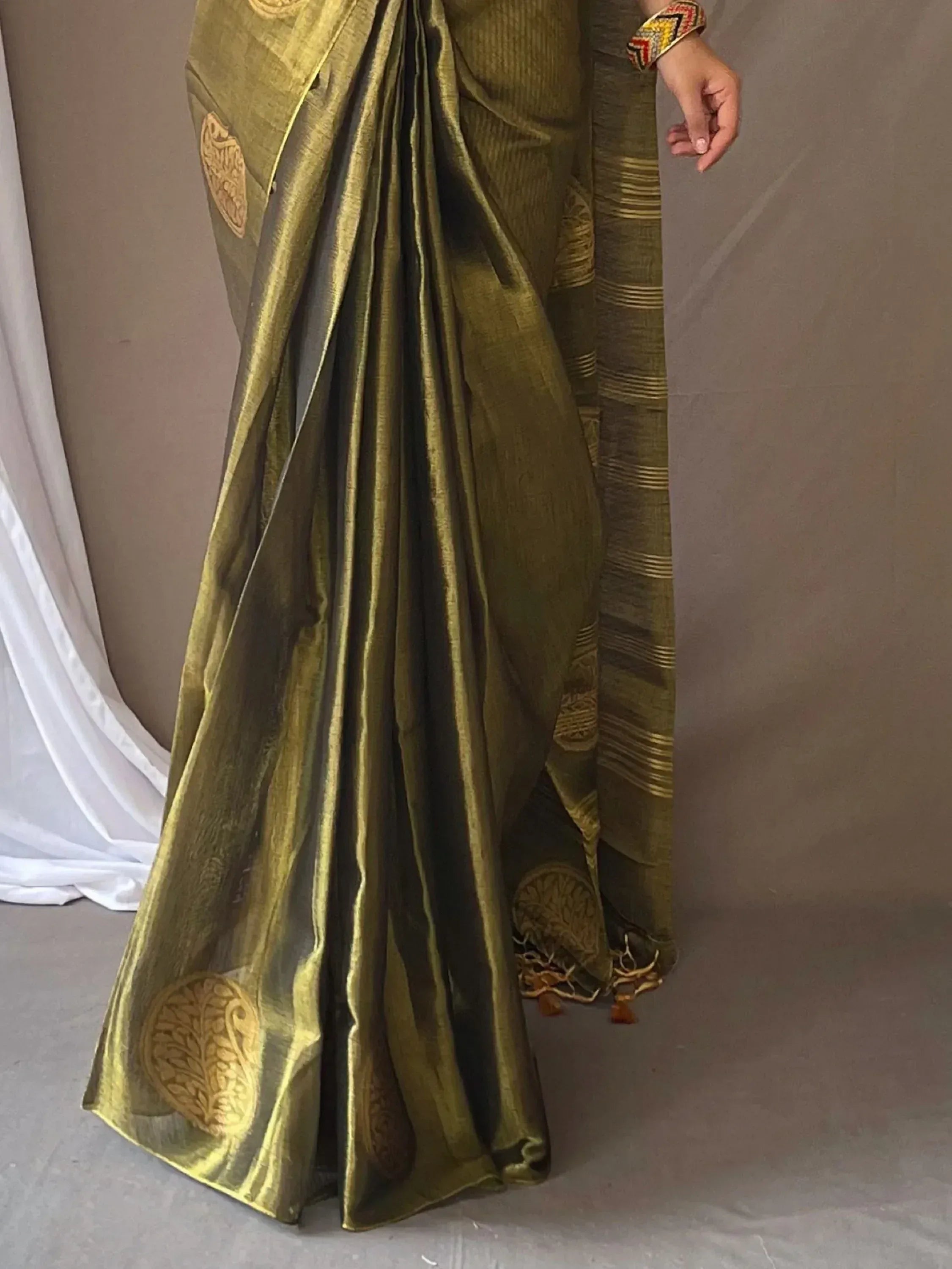 Olive green ethnic saree with gold floral motifs and striped border, perfect for Indian occasions
