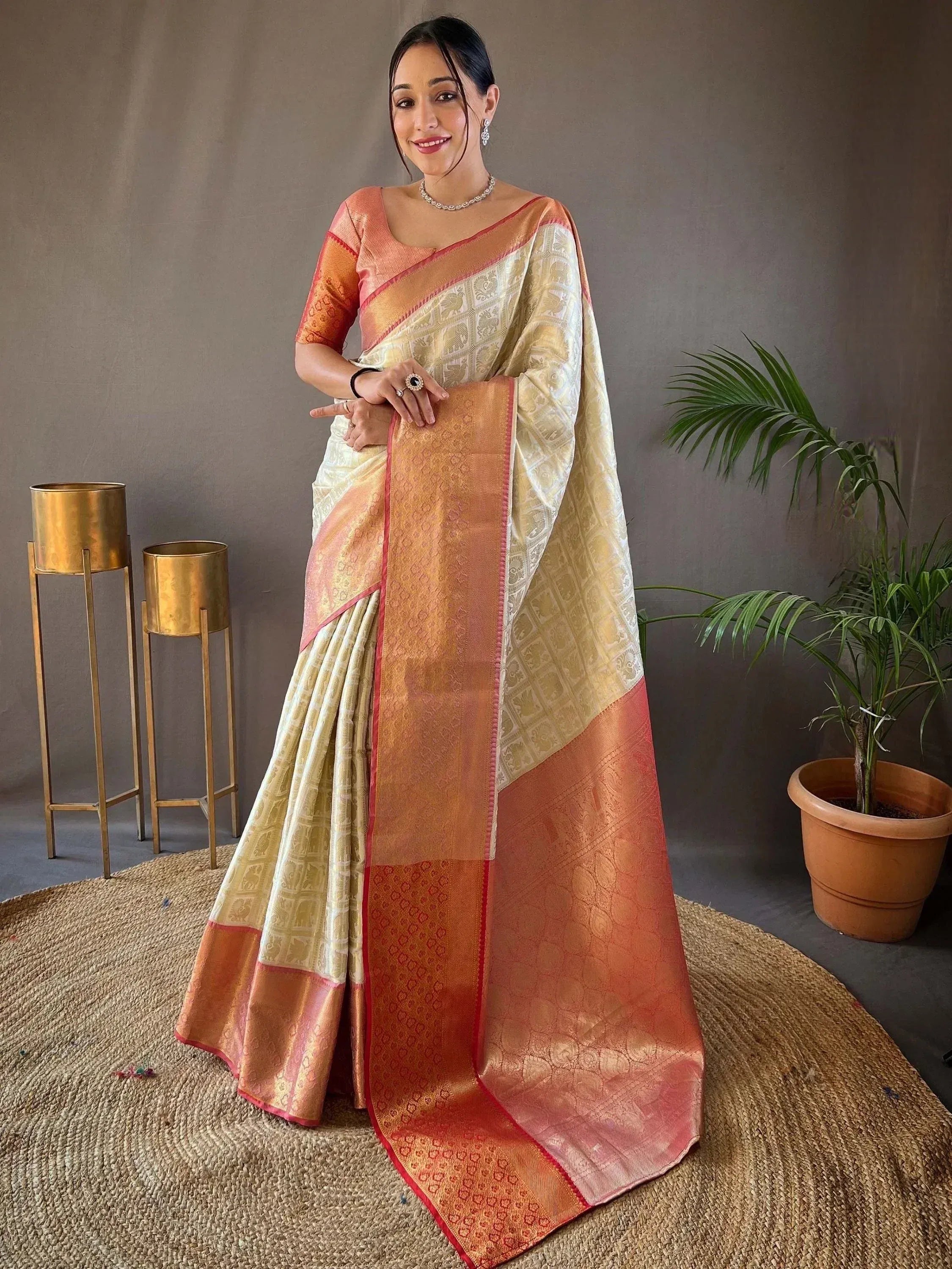 Woman in elegant peach and gold designer saree with intricate patterns, perfect for Indian ethnic wear occasions