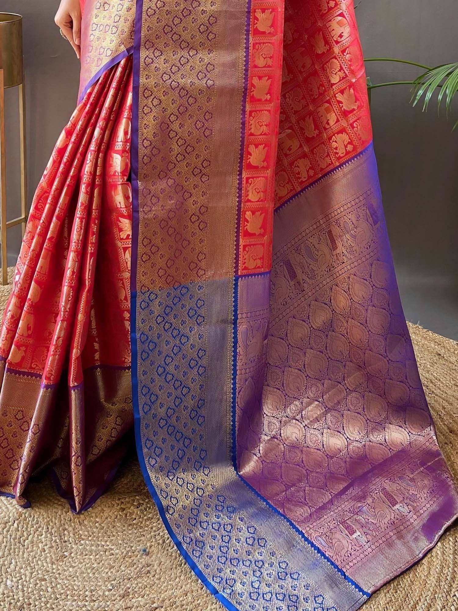 Red and purple designer saree with gold elephant motifs and intricate border patterns