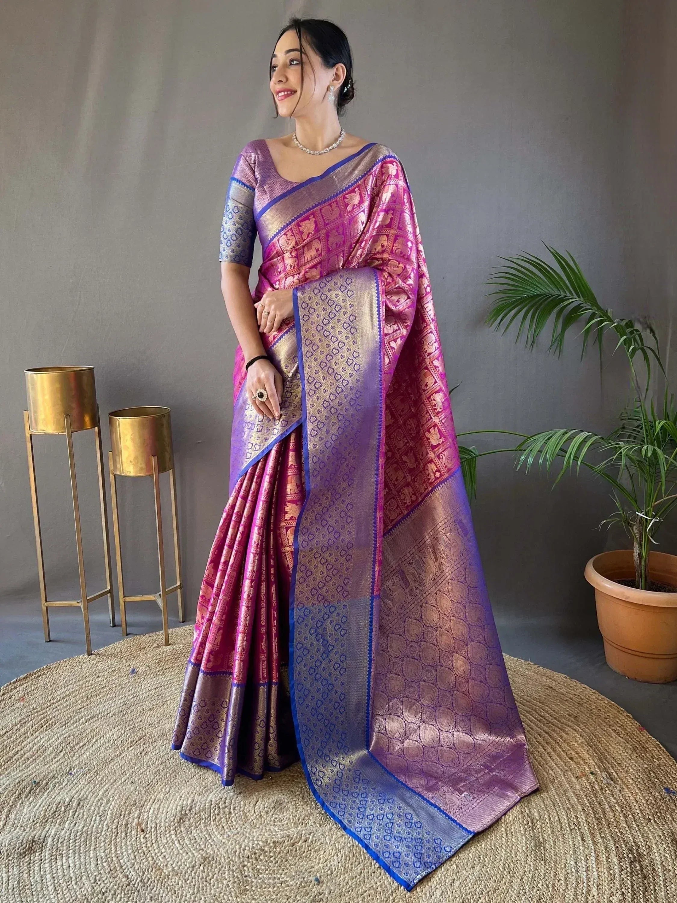 Elegant pink and purple designer saree with intricate elephant motifs and gold border