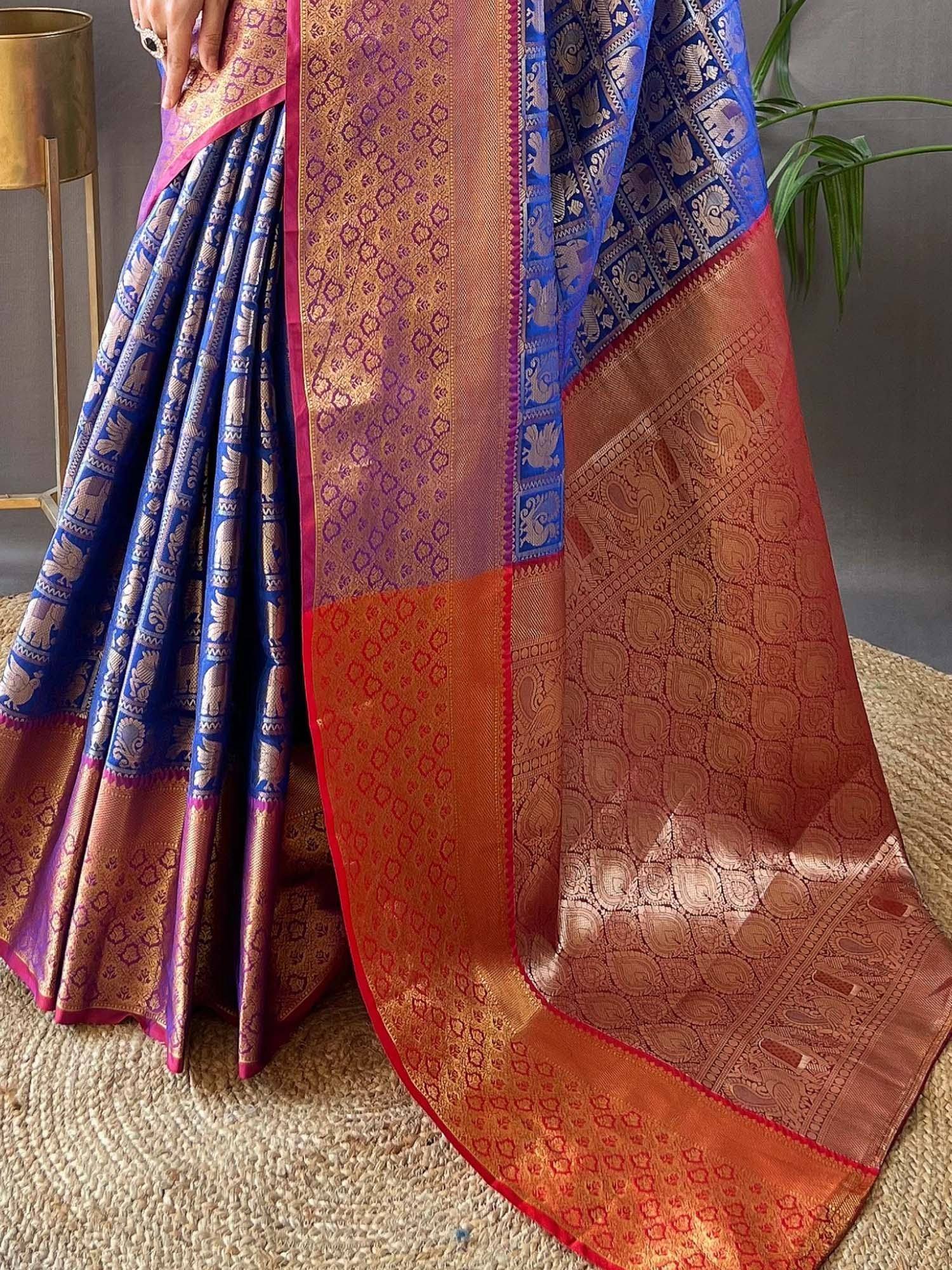 Blue and orange designer saree with elephant and paisley motifs, perfect for Indian ethnic wear occasions
