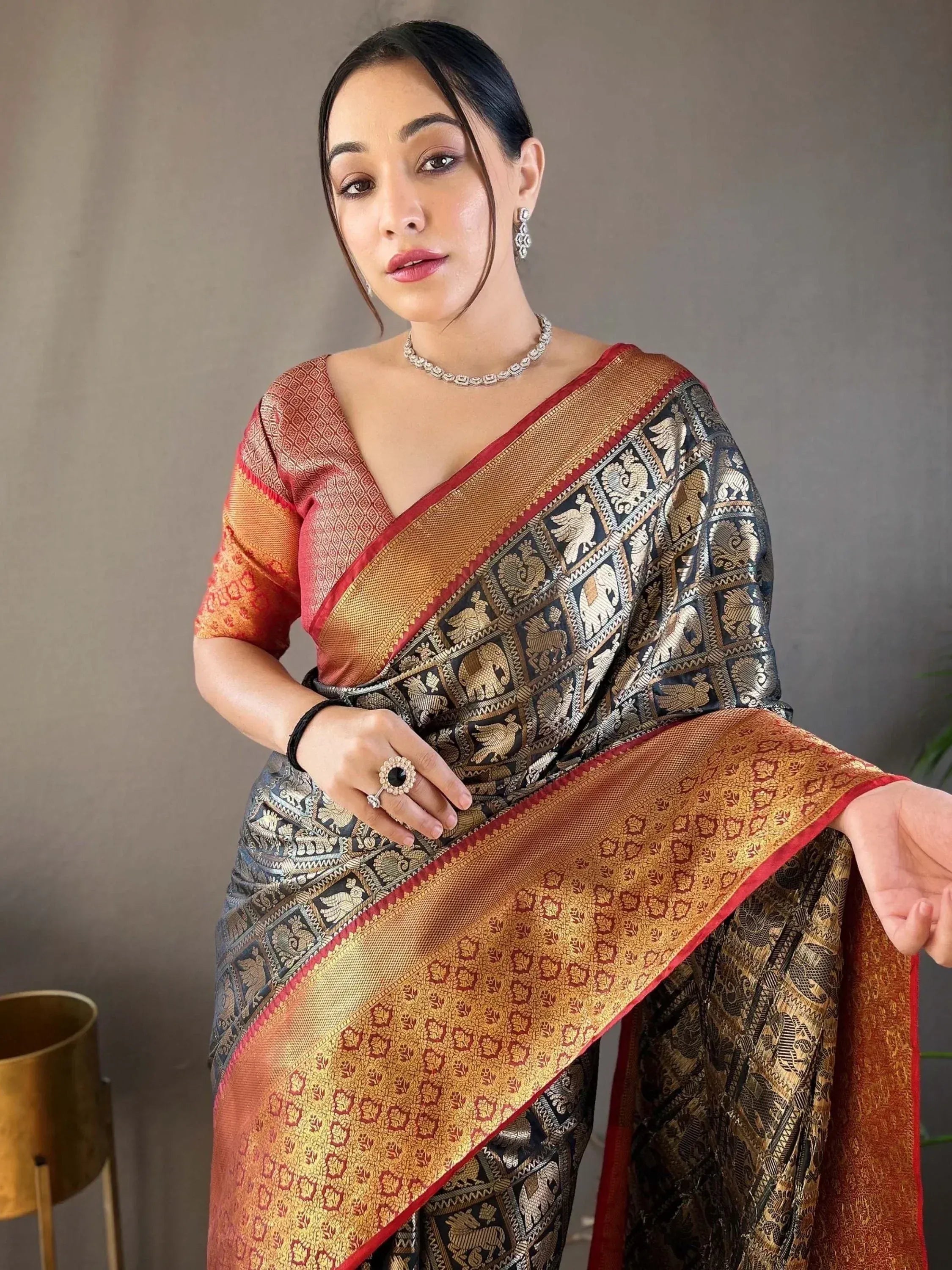 Elegant Indian saree with intricate elephant and floral patterns, perfect for ethnic wear occasions.