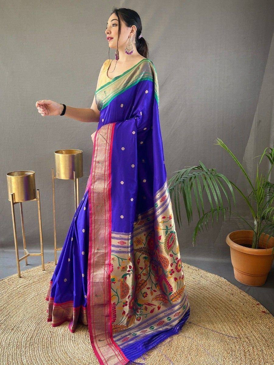 Woman in vibrant purple designer saree with floral border and gold blouse, ethnic Indian wear