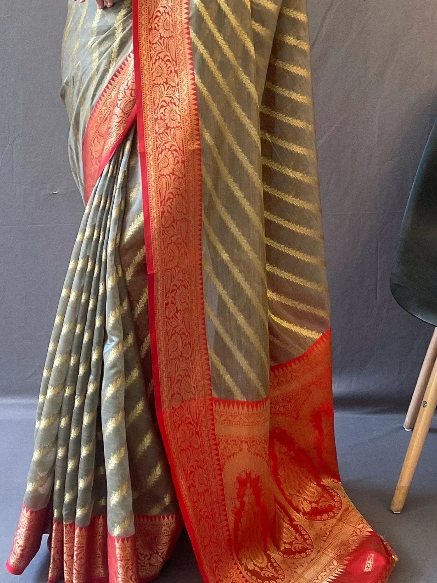 Grey and red designer saree with gold zari stripes and intricate border, perfect for ethnic occasions