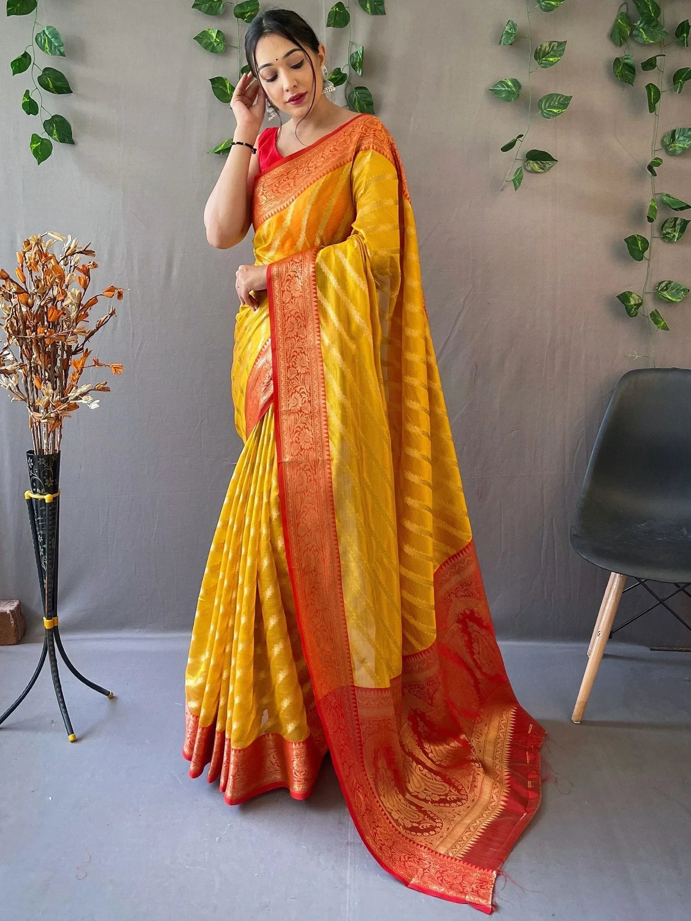 Yellow and orange designer saree with intricate border, perfect for ethnic occasions