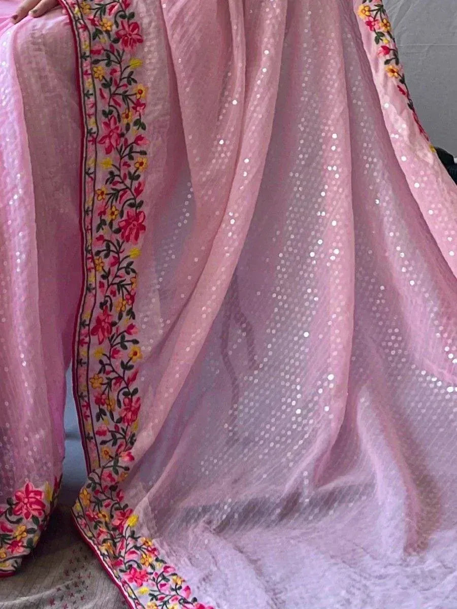Pink sequin ethnic saree with floral embroidered border, perfect for Indian festive wear