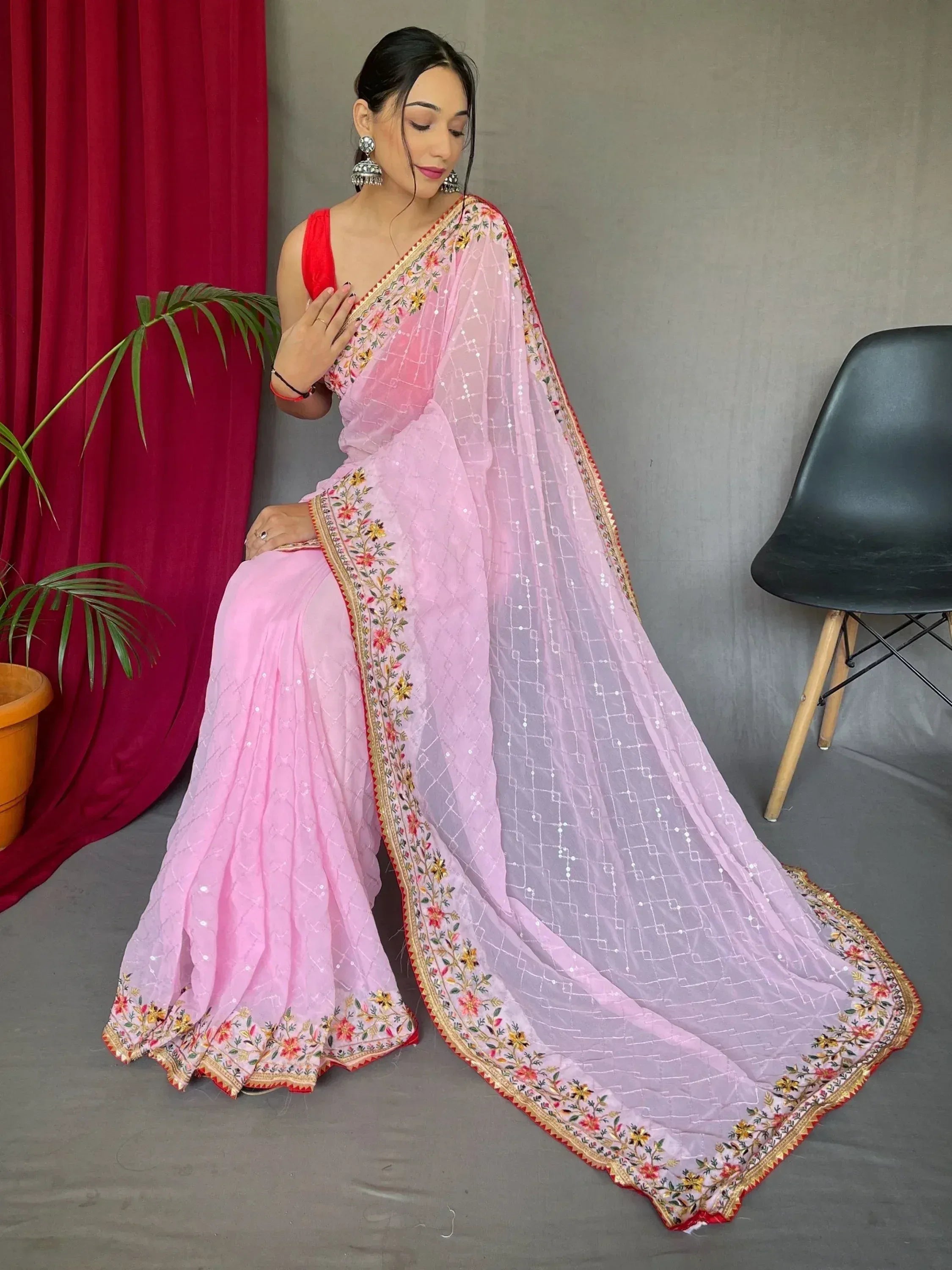 Pink embroidered saree with floral border and sequin work, paired with red blouse, Indian ethnic wear