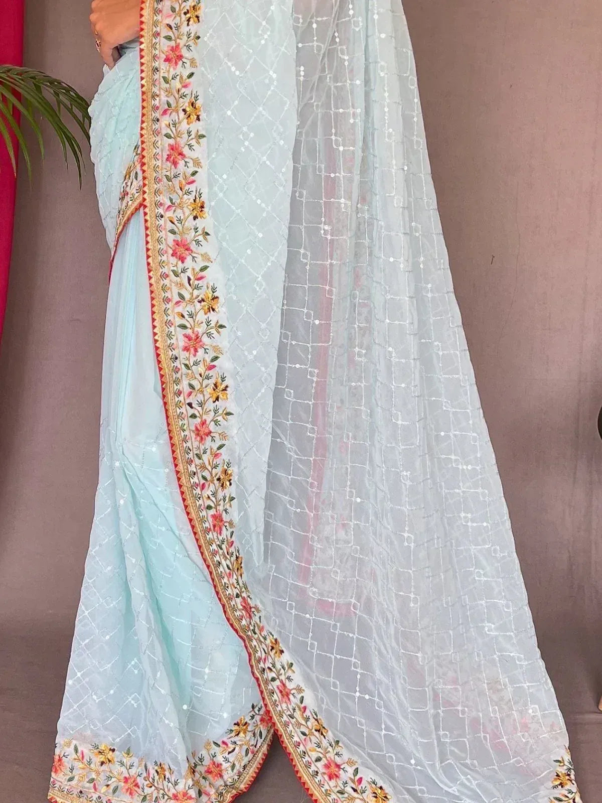 Light blue ethnic saree with floral embroidery and sequin border, perfect for Indian occasions