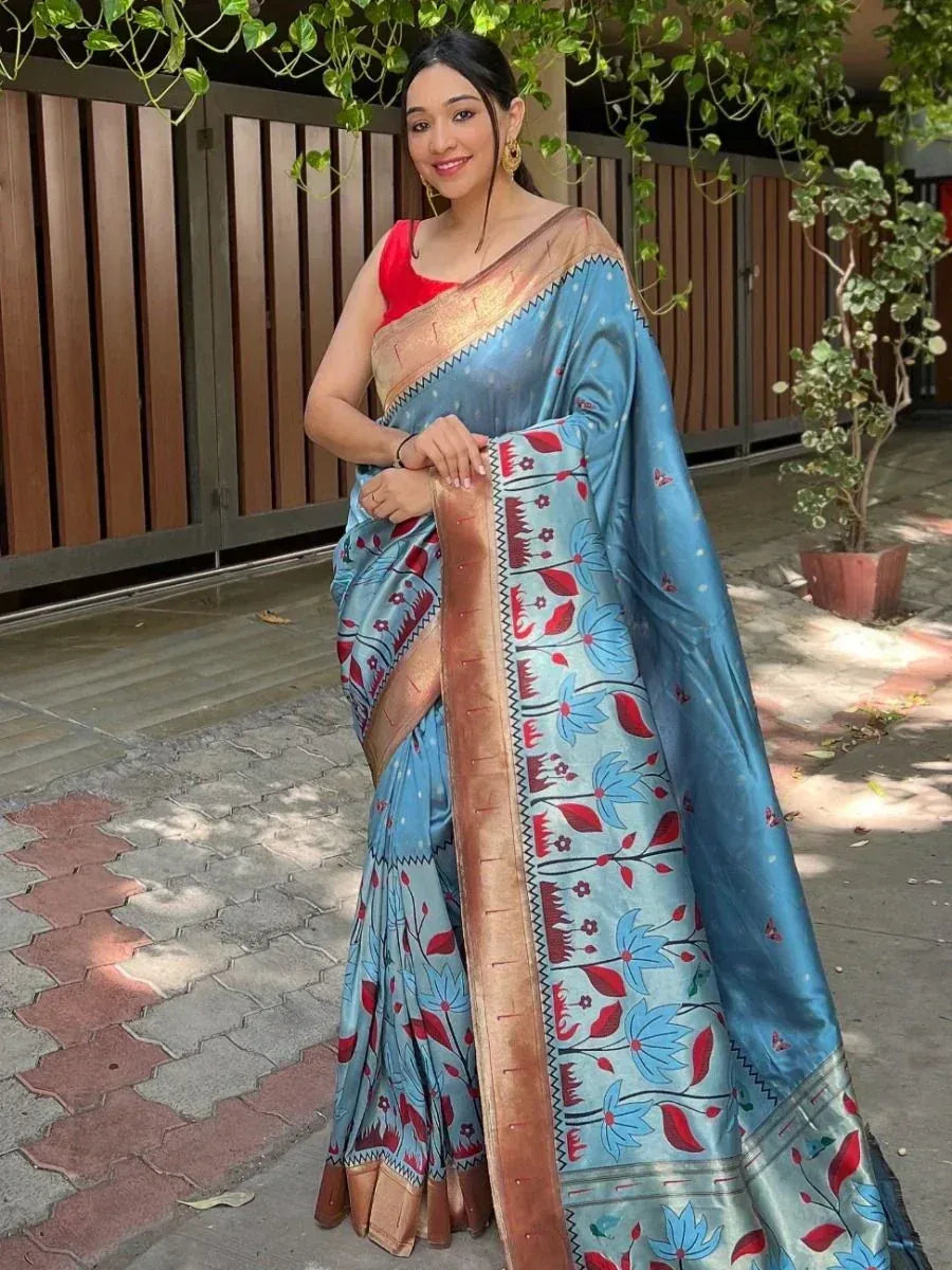 Blue floral saree with red and gold border, paired with red blouse, perfect for ethnic occasions