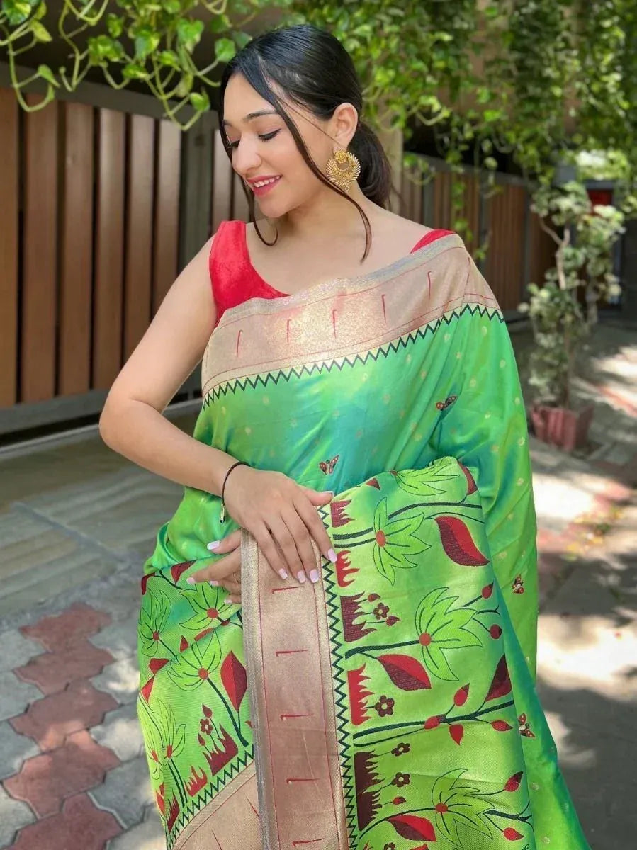 Woman in vibrant green floral saree with red blouse, ethnic Indian wear for festive occasions