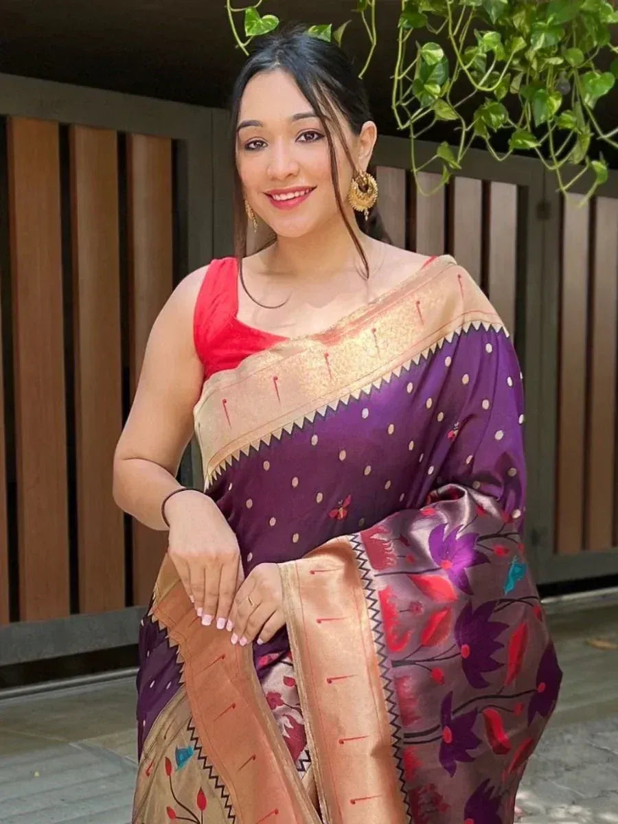 Woman in purple floral saree with gold border and red blouse, ethnic Indian wear