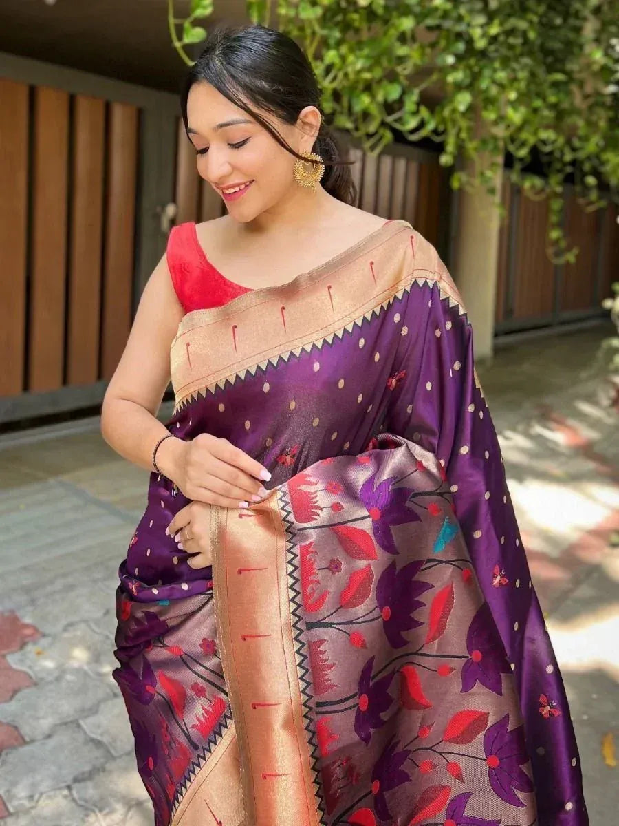 Woman in purple floral saree with gold border and red blouse, ethnic Indian wear