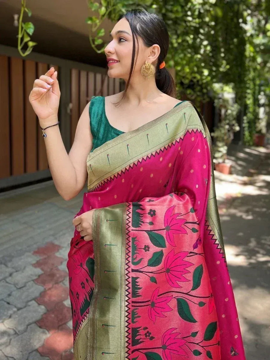 Woman in pink floral saree with green border and matching blouse, styled for ethnic occasions