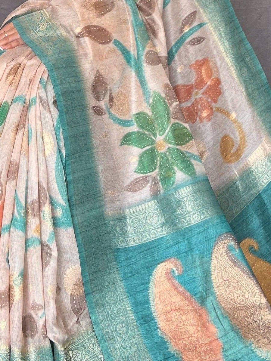 Teal and cream printed saree with floral and paisley motifs, perfect for ethnic wear