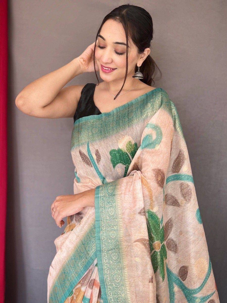 Woman in elegant floral print saree with teal border, styled with black blouse for ethnic wear