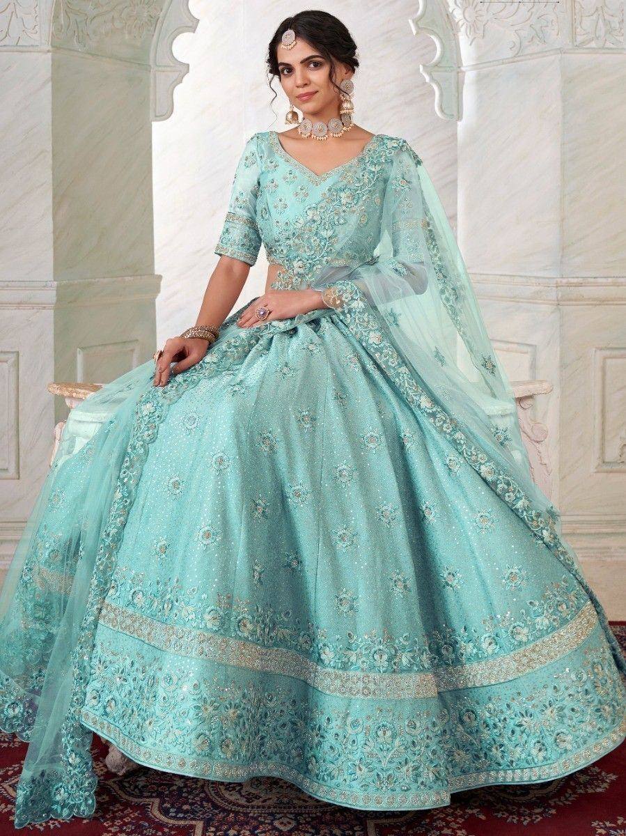 Mint green designer lehenga choli with intricate embroidery and sheer dupatta, perfect for Indian weddings