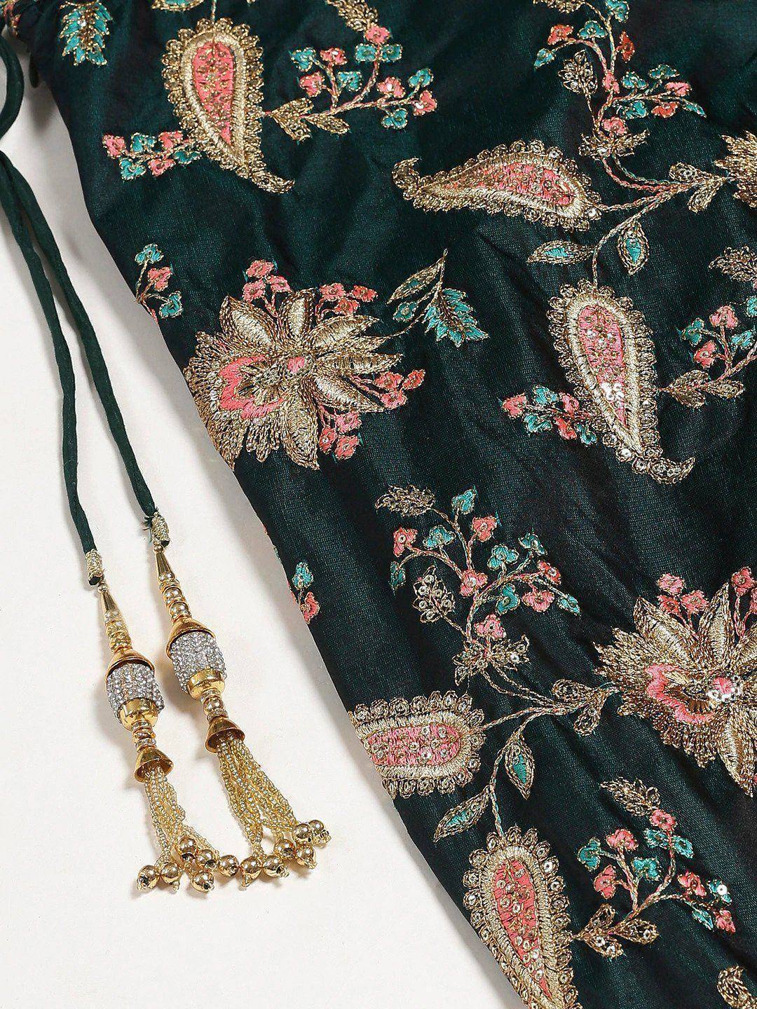 Emerald green ethnic gown with gold floral embroidery and beaded tassels, perfect for Indian weddings or festive occasions.