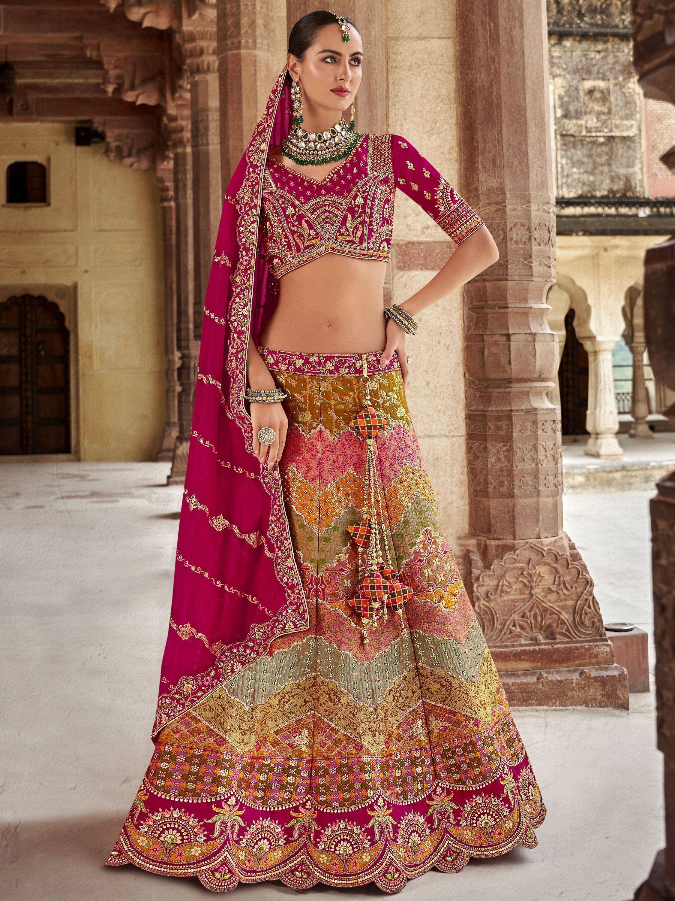 Elegant magenta and gold embroidered lehenga choli with dupatta, perfect for Indian weddings and festive occasions.