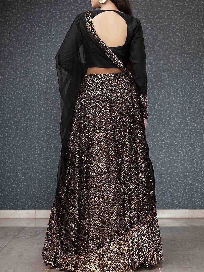 Black sequin lehenga choli with open back blouse and sheer sleeves, ethnic Indian wear