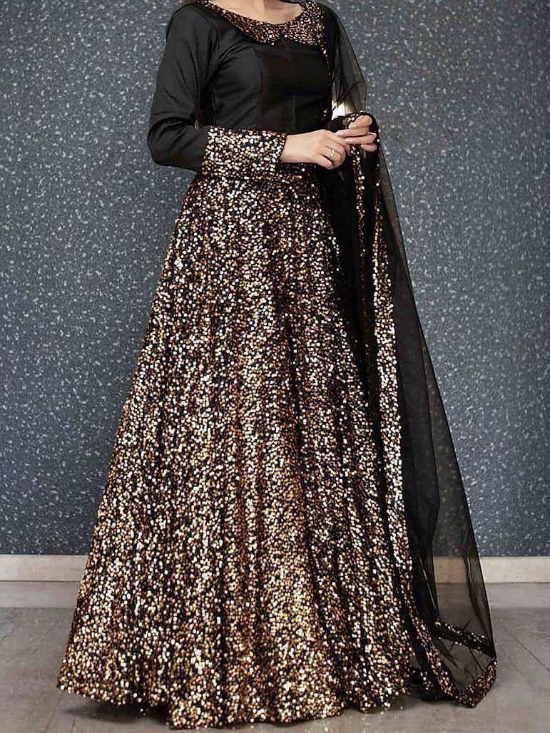 Black and gold sequin lehenga choli with sheer dupatta, elegant ethnic wear for women