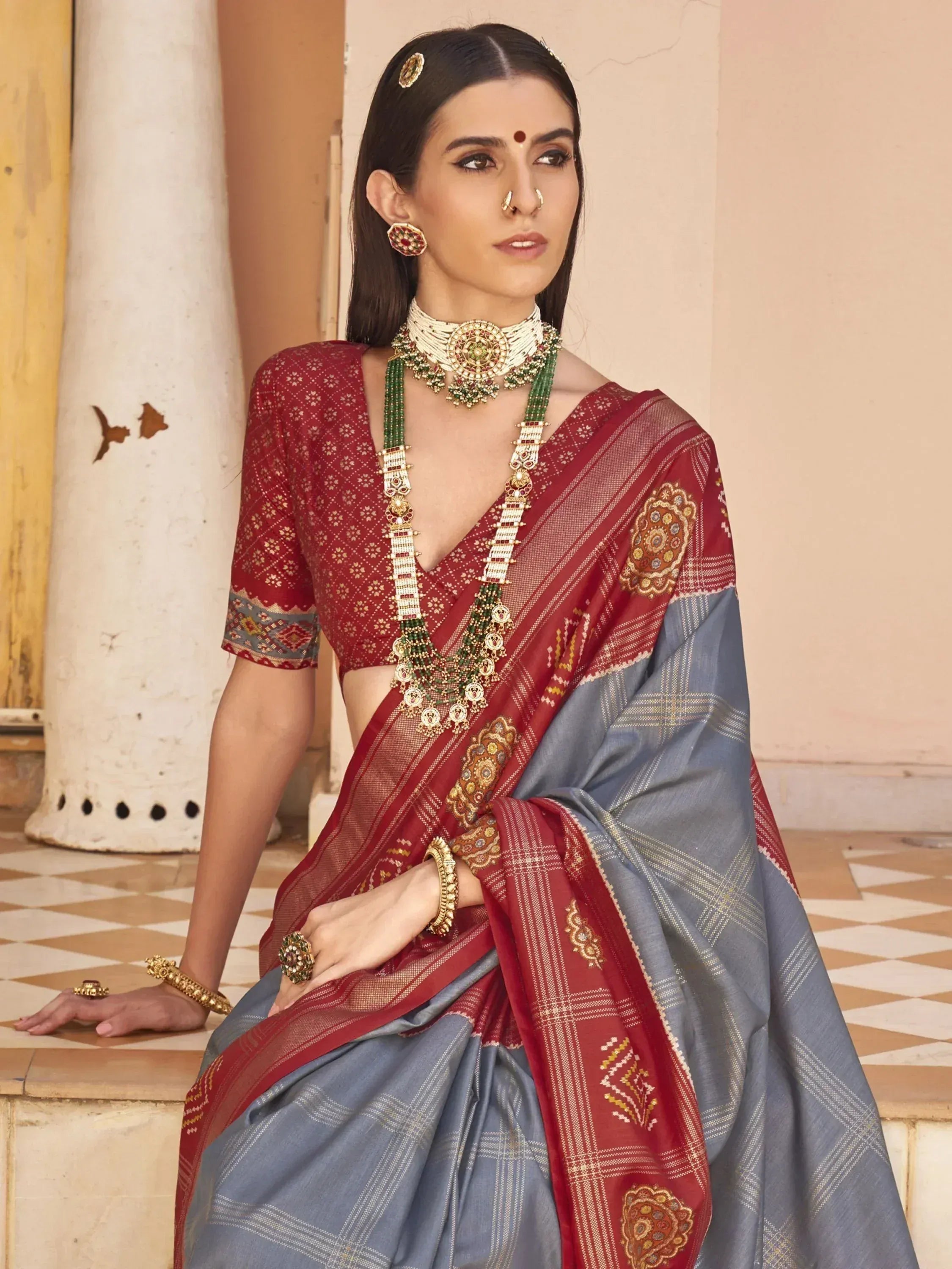 Woman in maroon and grey embroidered saree with traditional jewelry, Indian ethnic wear