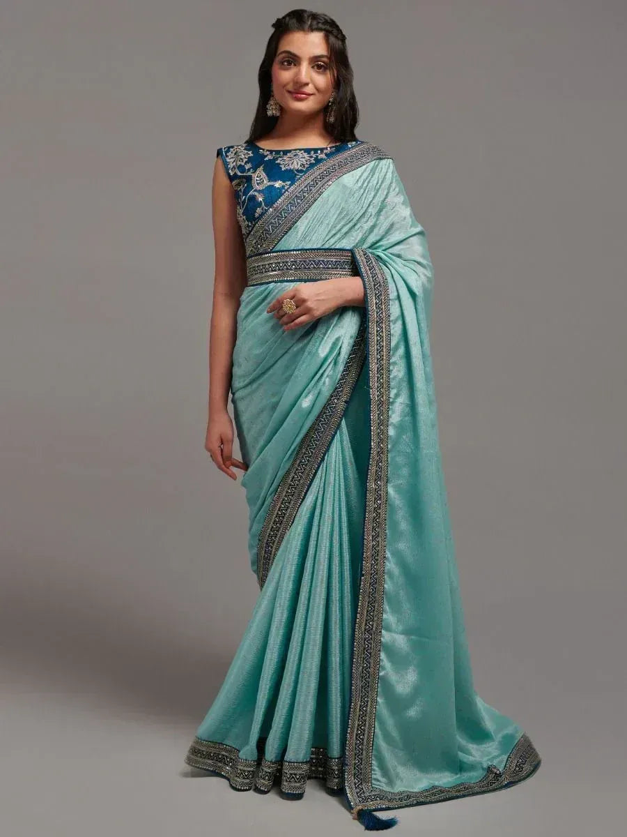 Elegant turquoise saree with intricate embroidery and border, paired with a blue blouse for Indian ethnic wear.