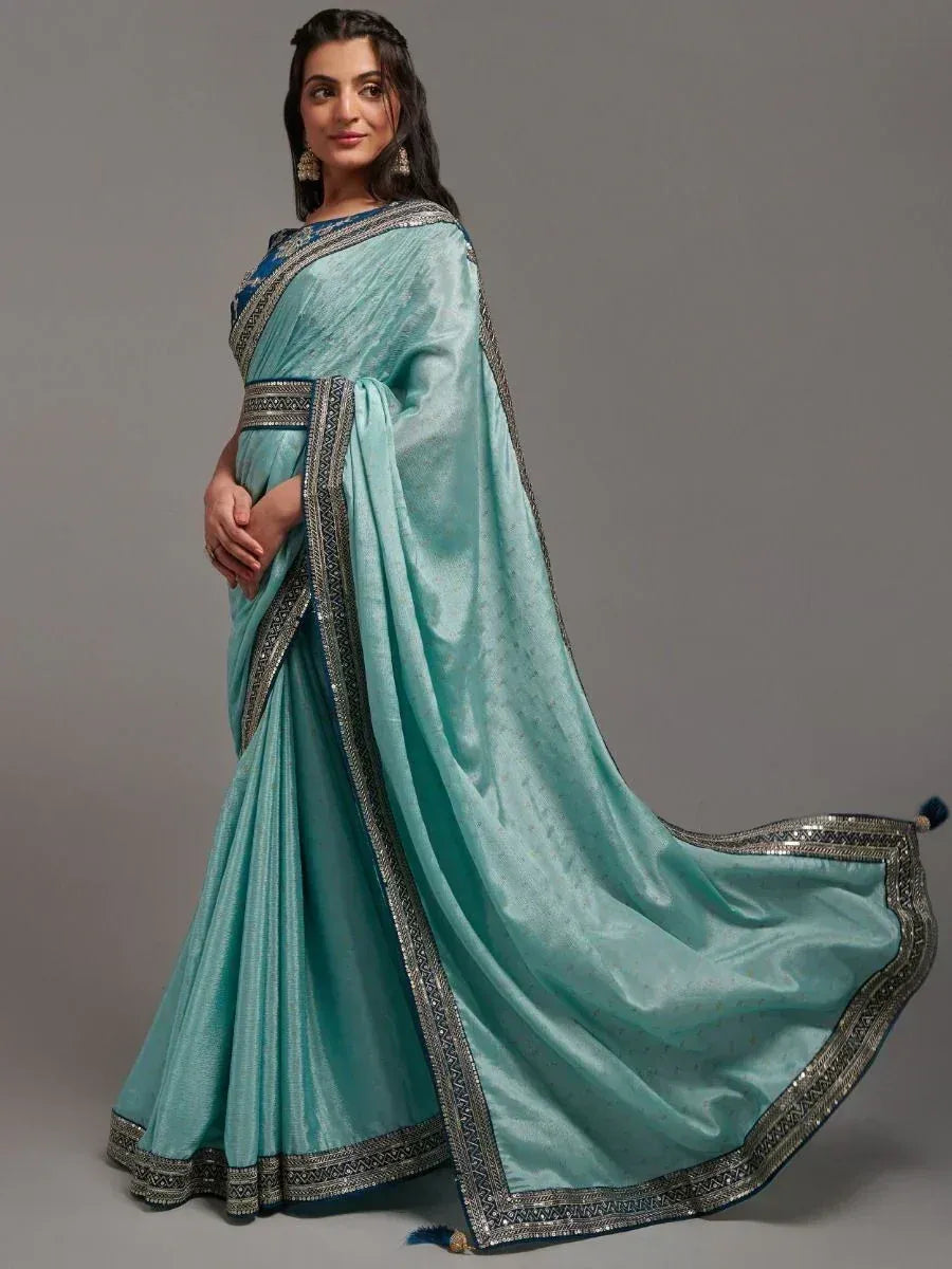 Elegant turquoise saree with silver border, perfect for Indian ethnic occasions and festive wear.