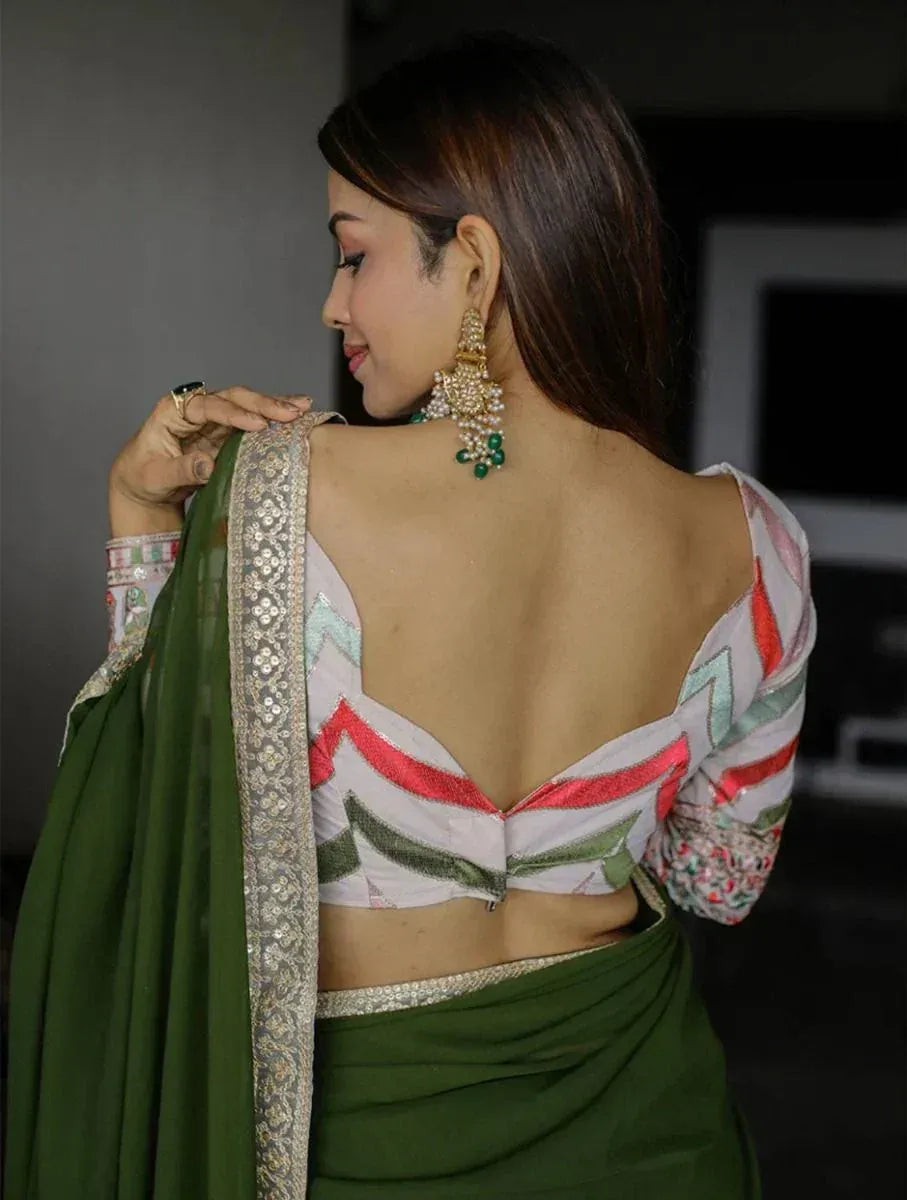Woman in green saree with embroidered blouse and statement earrings, showcasing ethnic Indian fashion