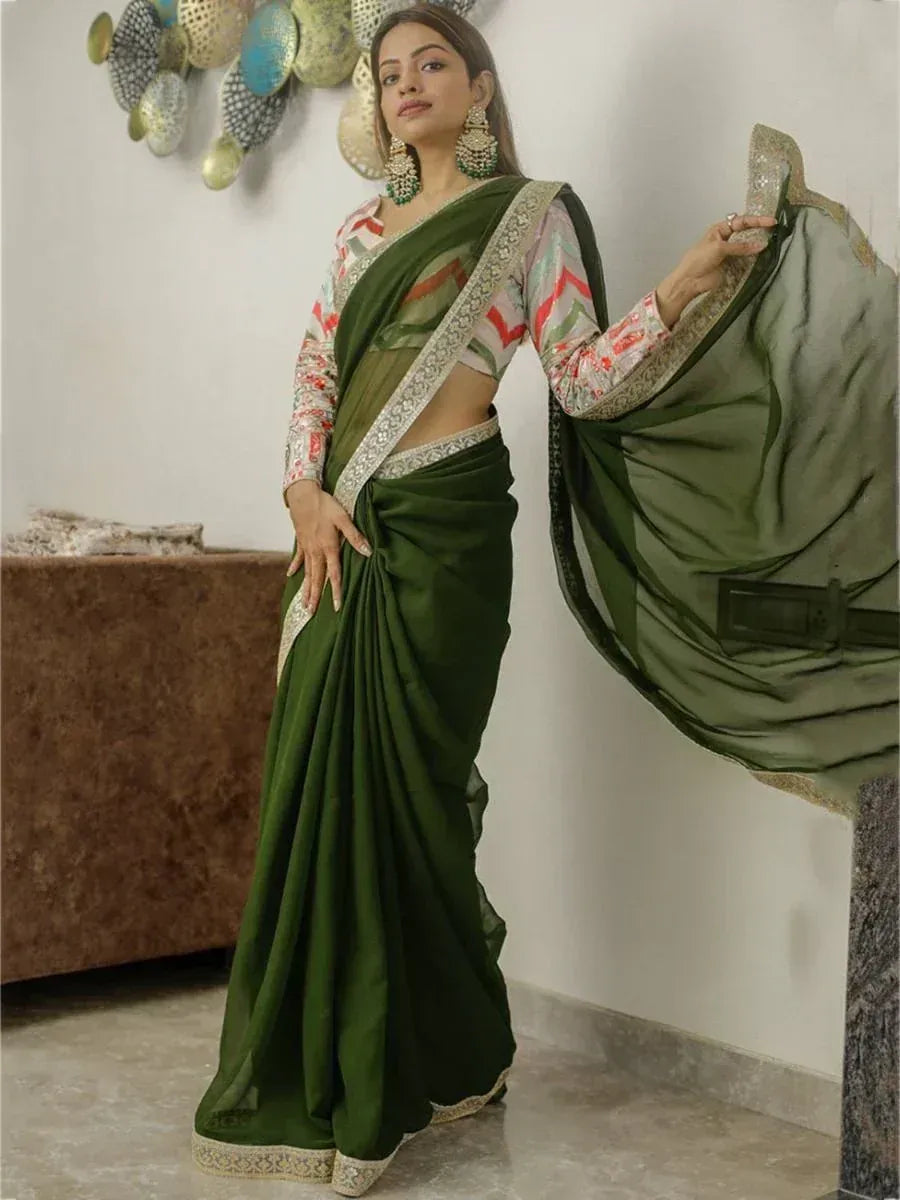 Elegant olive green saree with embroidered border, paired with printed blouse, perfect for Indian ethnic occasions.