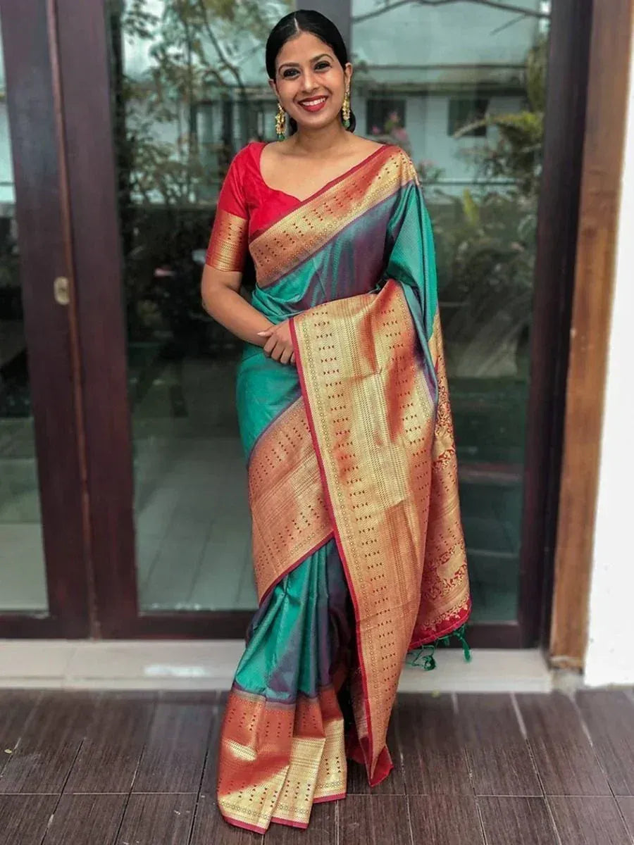 Woman in vibrant green and gold designer saree with red blouse, perfect for ethnic occasions