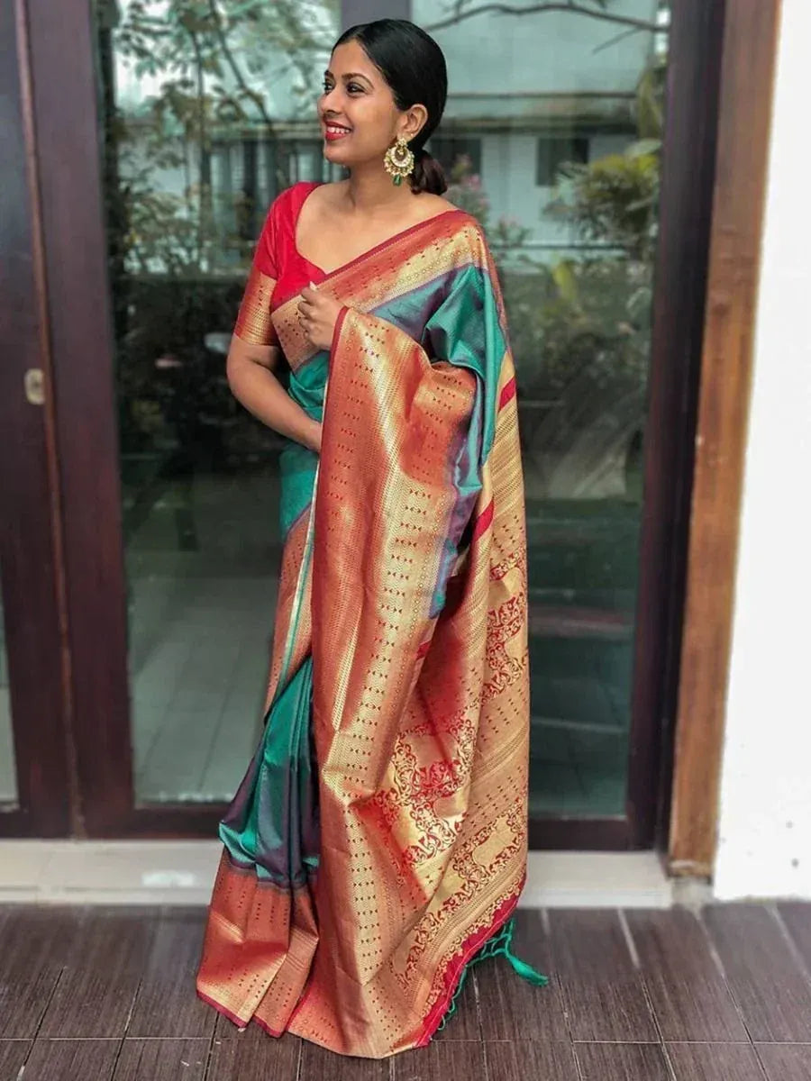 Woman in vibrant green and gold designer saree with red blouse, perfect for Indian ethnic occasions