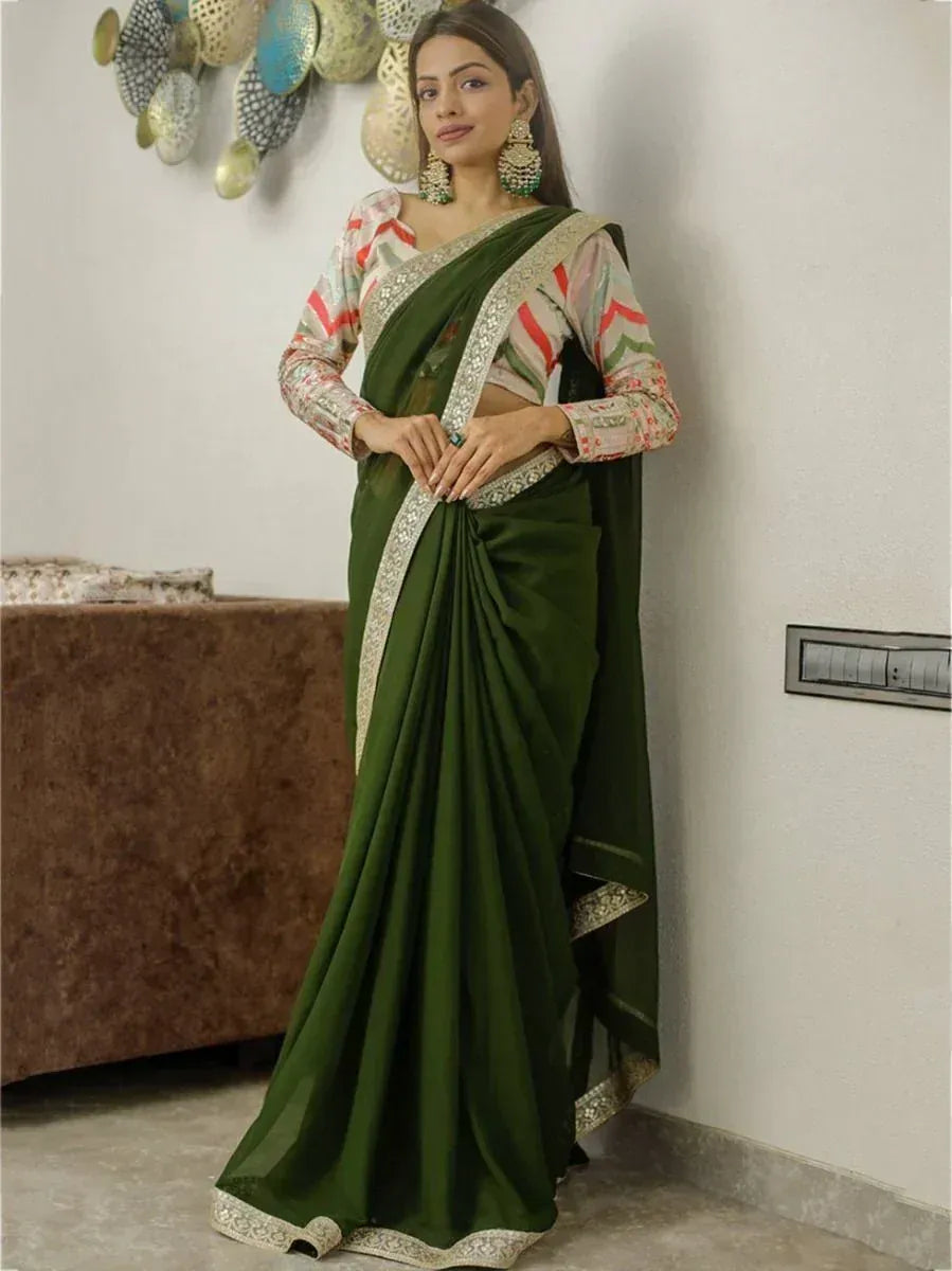Elegant green saree with silver border, paired with printed blouse, perfect for Indian ethnic occasions.