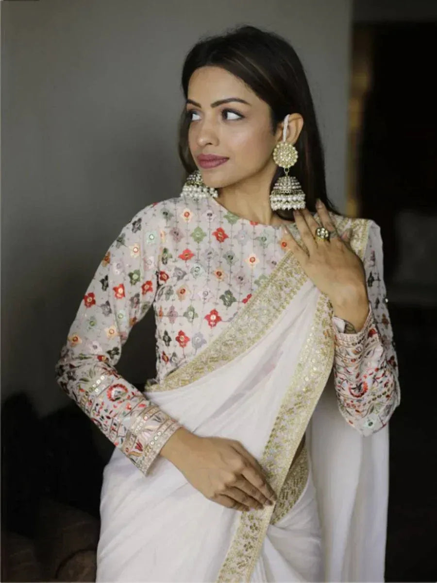 Woman in white embroidered saree with floral blouse, traditional Indian ethnic wear