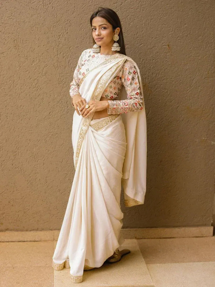 Elegant white saree with floral blouse and gold border, perfect for Indian ethnic occasions