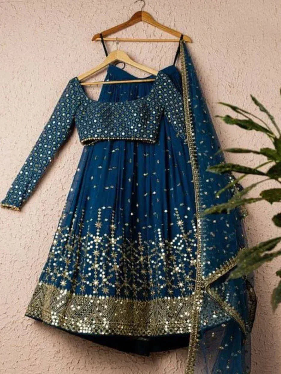 Blue embroidered lehenga choli with mirror work and gold detailing, perfect for Indian ethnic wear occasions.