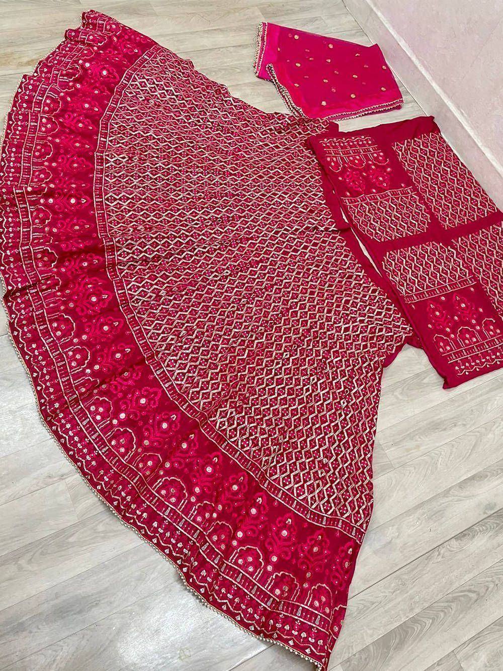 Red embroidered lehenga choli set with geometric and floral patterns, perfect for Indian ethnic wear