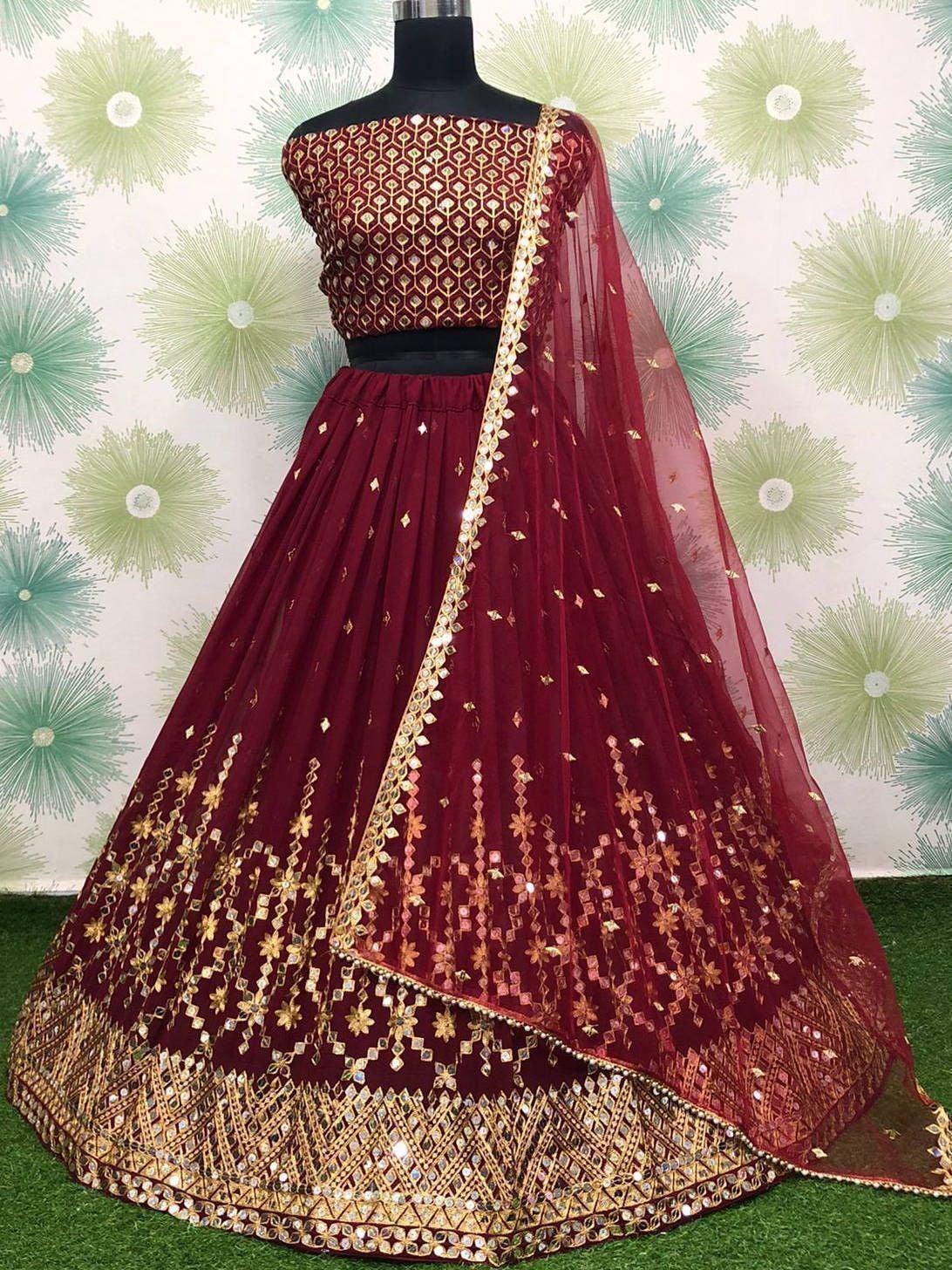 Maroon designer lehenga choli with gold mirror work and sheer dupatta, perfect for Indian ethnic occasions