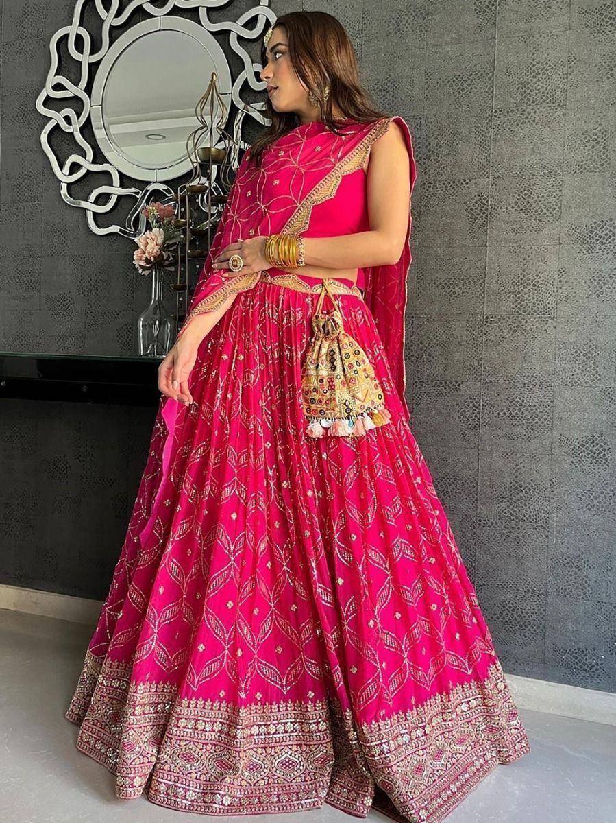 Pink embroidered lehenga choli with gold detailing, perfect for Indian weddings and festive occasions