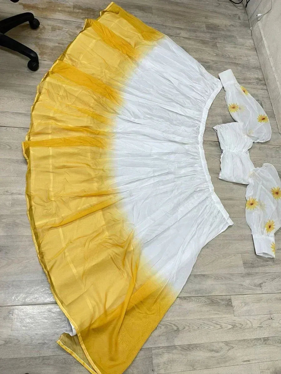Yellow and white ombre ethnic gown with floral sleeves, laid flat on wooden floor
